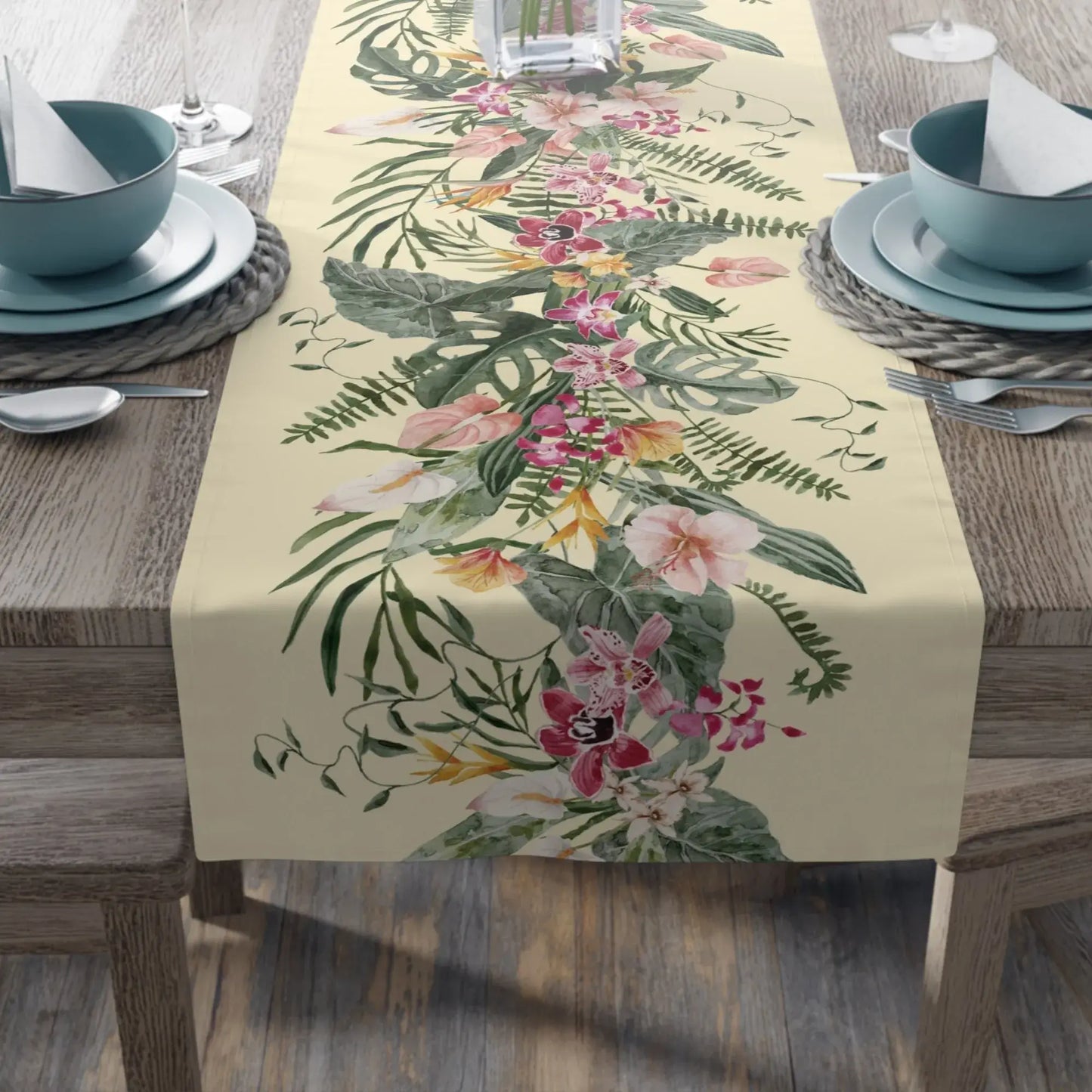 Floral Tropical TABLE RUNNER featuring a light yellow background with orchids and tropical greenery on a dining table.