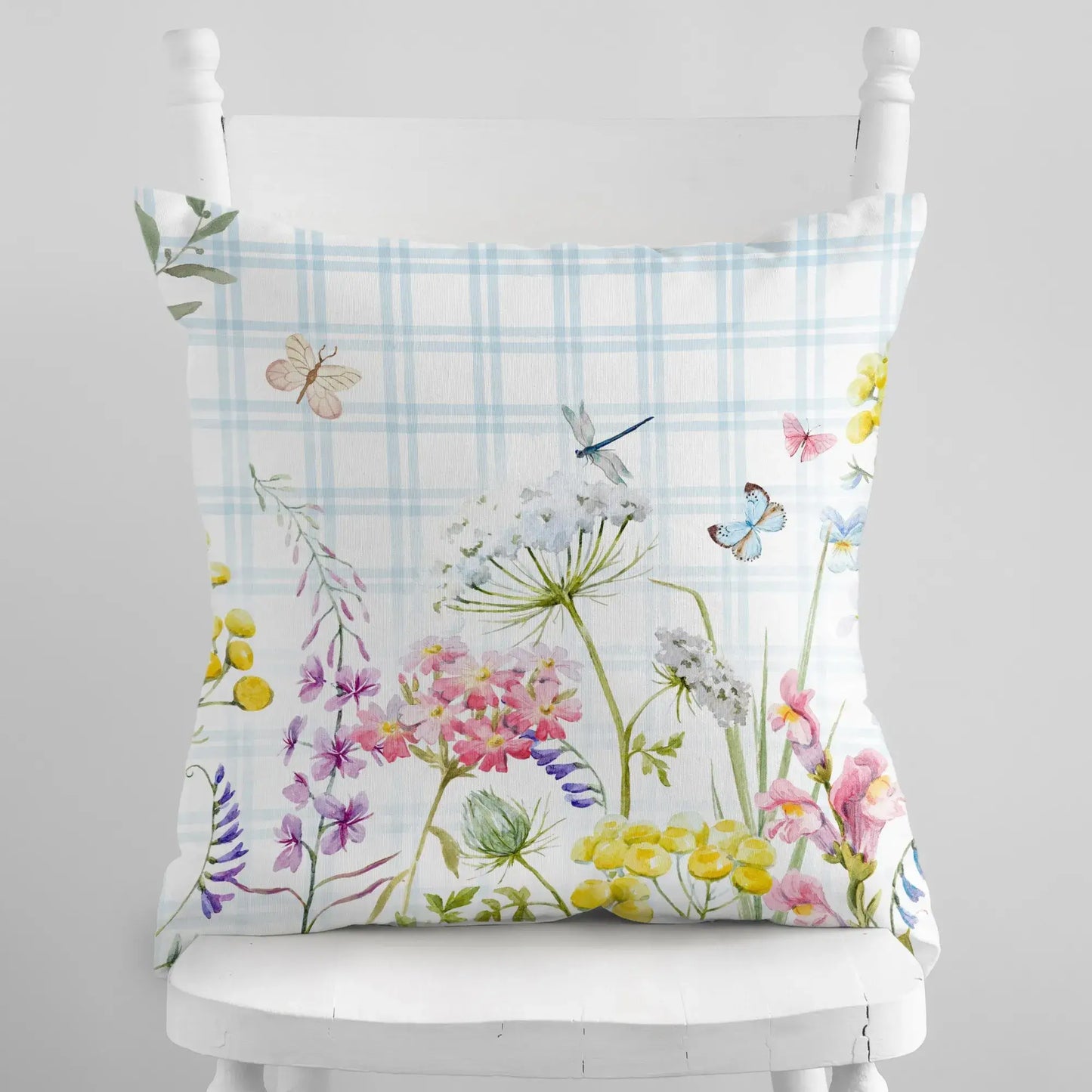 Watercolor blue floral pillow cover with botanical garden design on cream background.