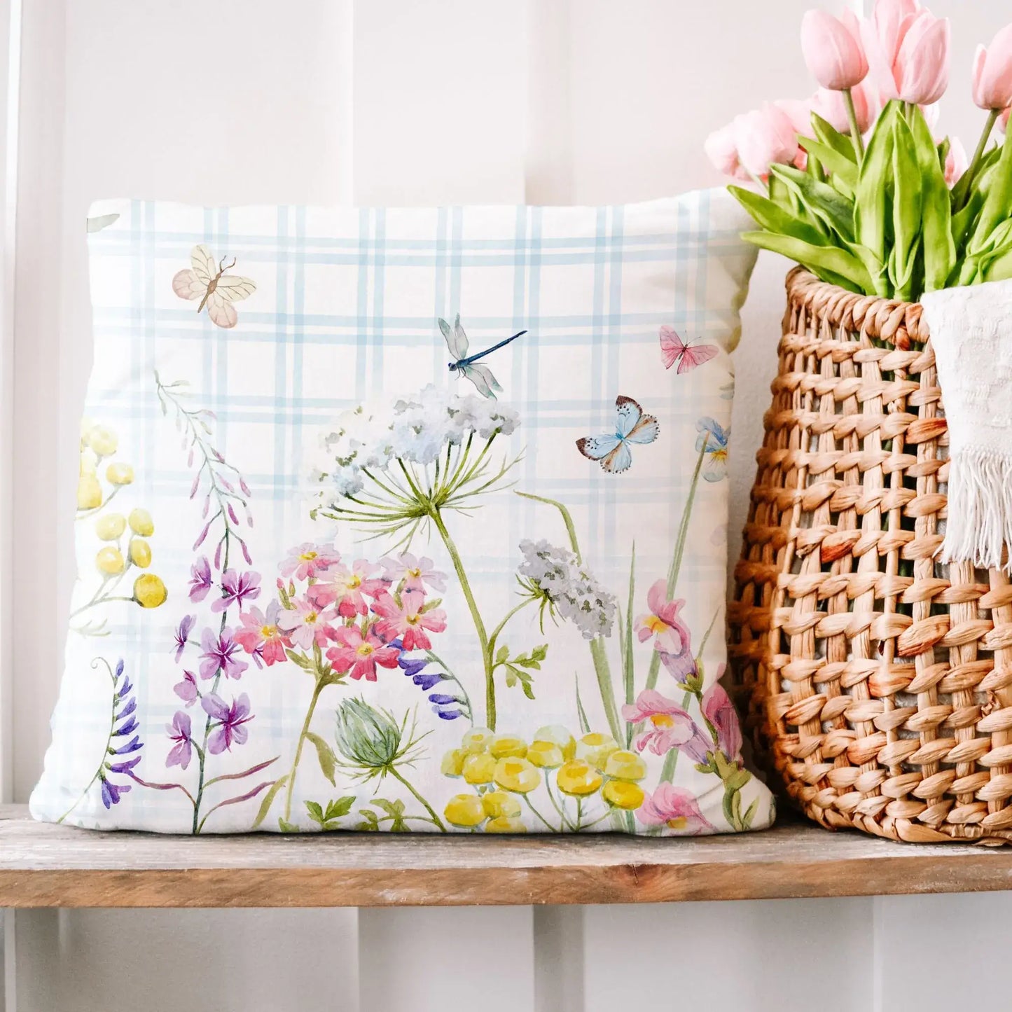 Romantic spring floral throw pillow featuring watercolor wildflowers, butterflies, and dragonflies on soft blue plaid — perfect for cottagecore decor, porch refresh, or nature-inspired home styling.