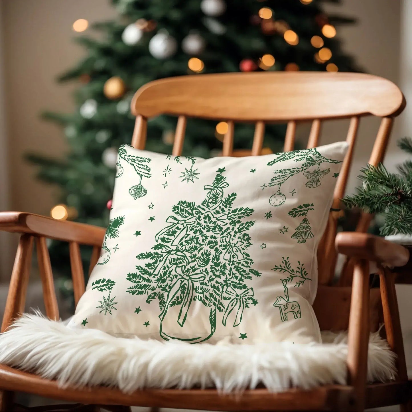Green botanical Christmas tree pillow cover on wooden chair with holiday tree background