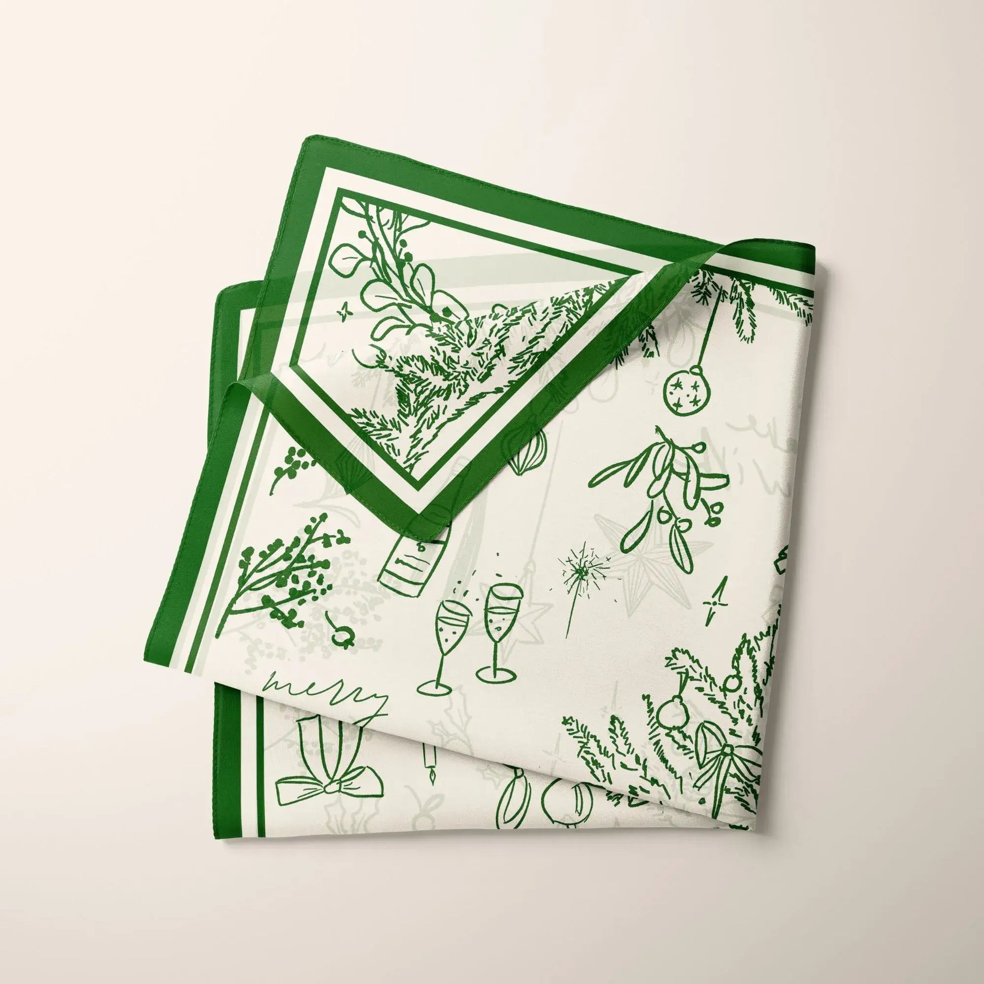 Green Christmas Silk Scarf folded neatly to show pine branches and ribbon details magic story style