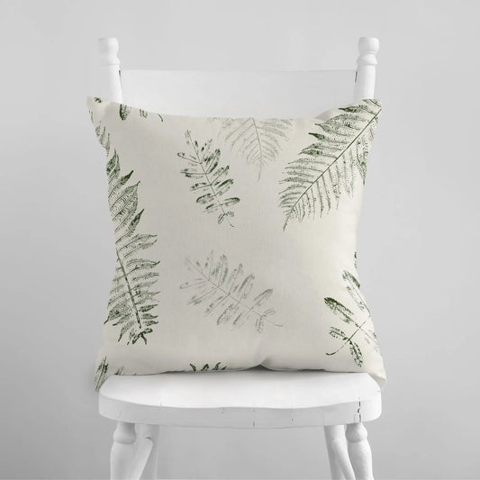 white chair with Green Leaves PILLOW from Blue Water Songs on it