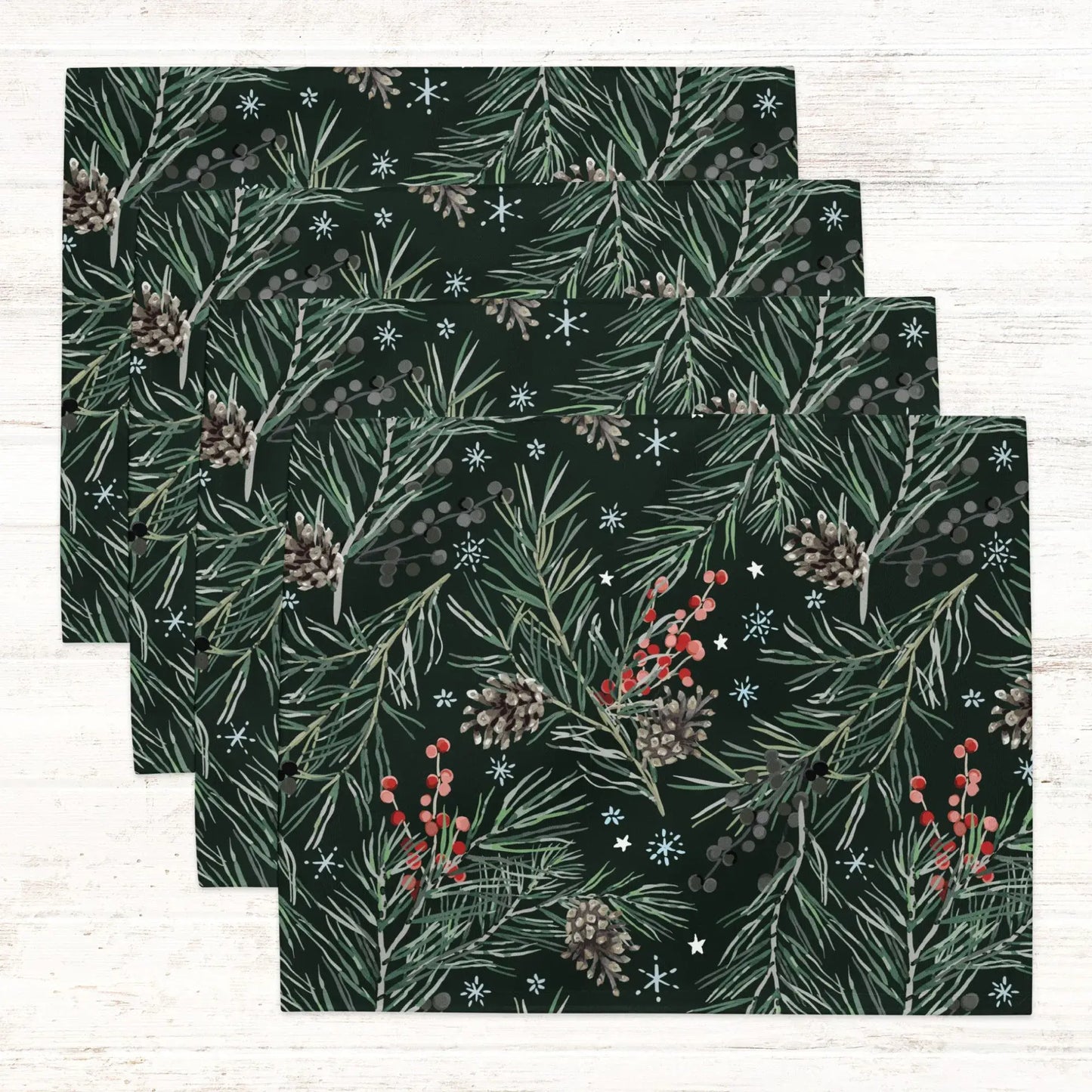 Green Pine and Berry Winter Botanical Placemats featuring lush pine branches and red berries on a dark background.