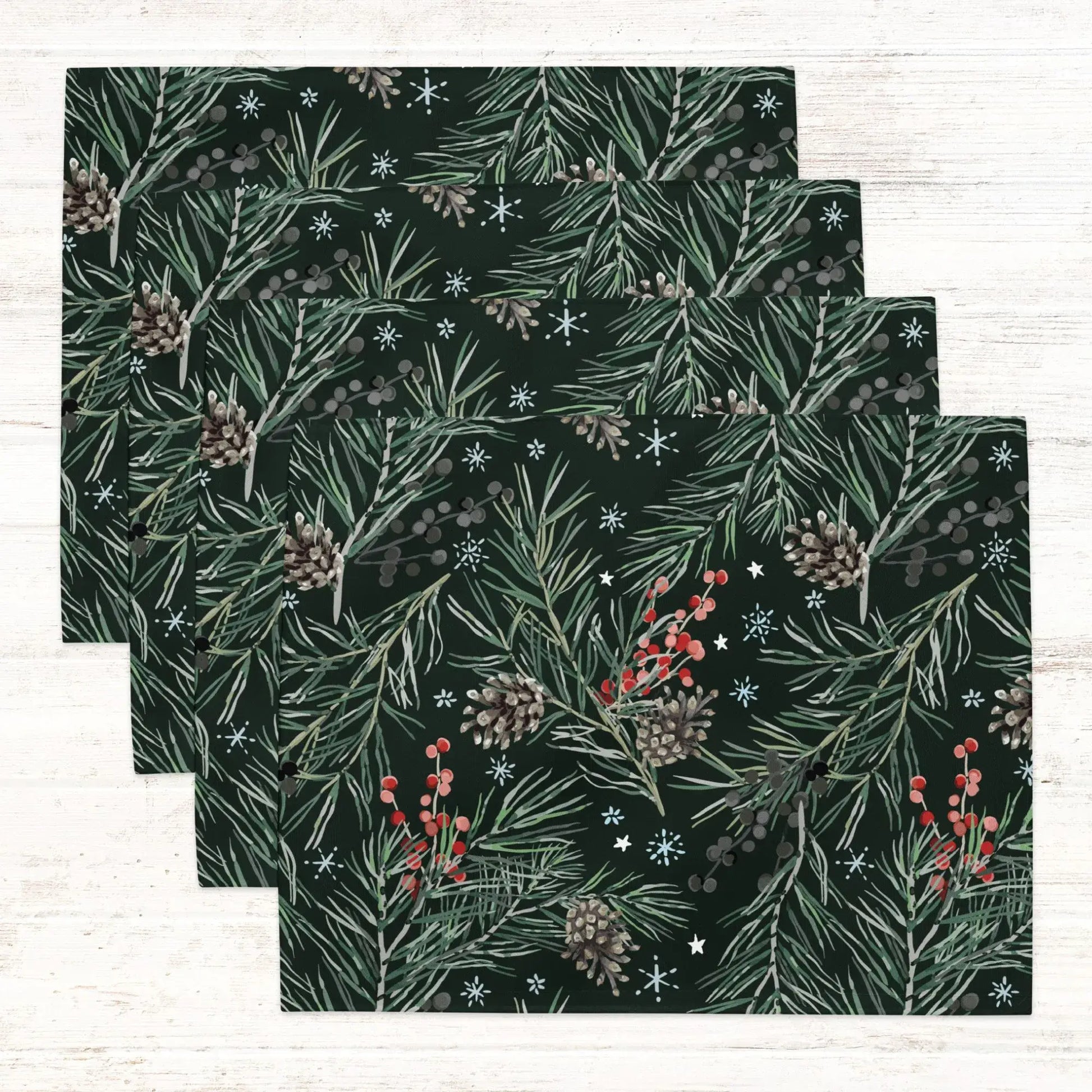 Green Pine and Berry Winter Botanical Placemats featuring lush pine branches and red berries on a dark background.