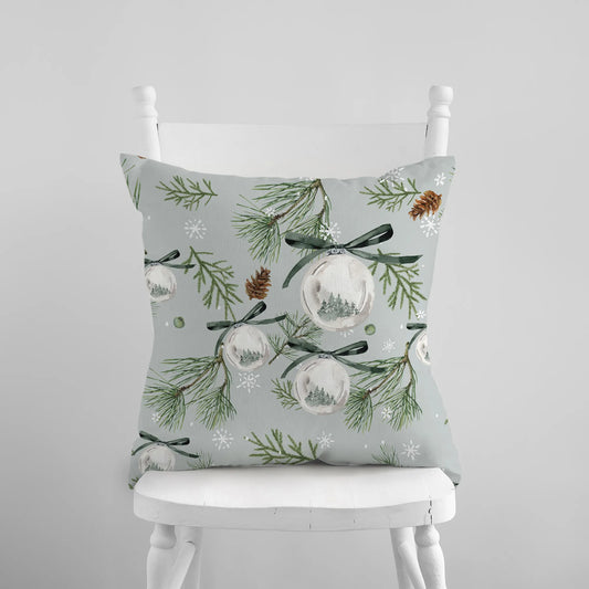 Watercolor green pine and ornament Christmas pillow on white chair – nature-inspired holiday decor