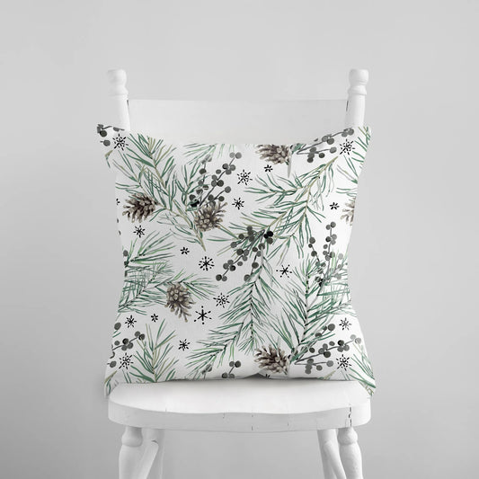 Green Winter Pine PILLOW from Blue Water Songs placing on white chair