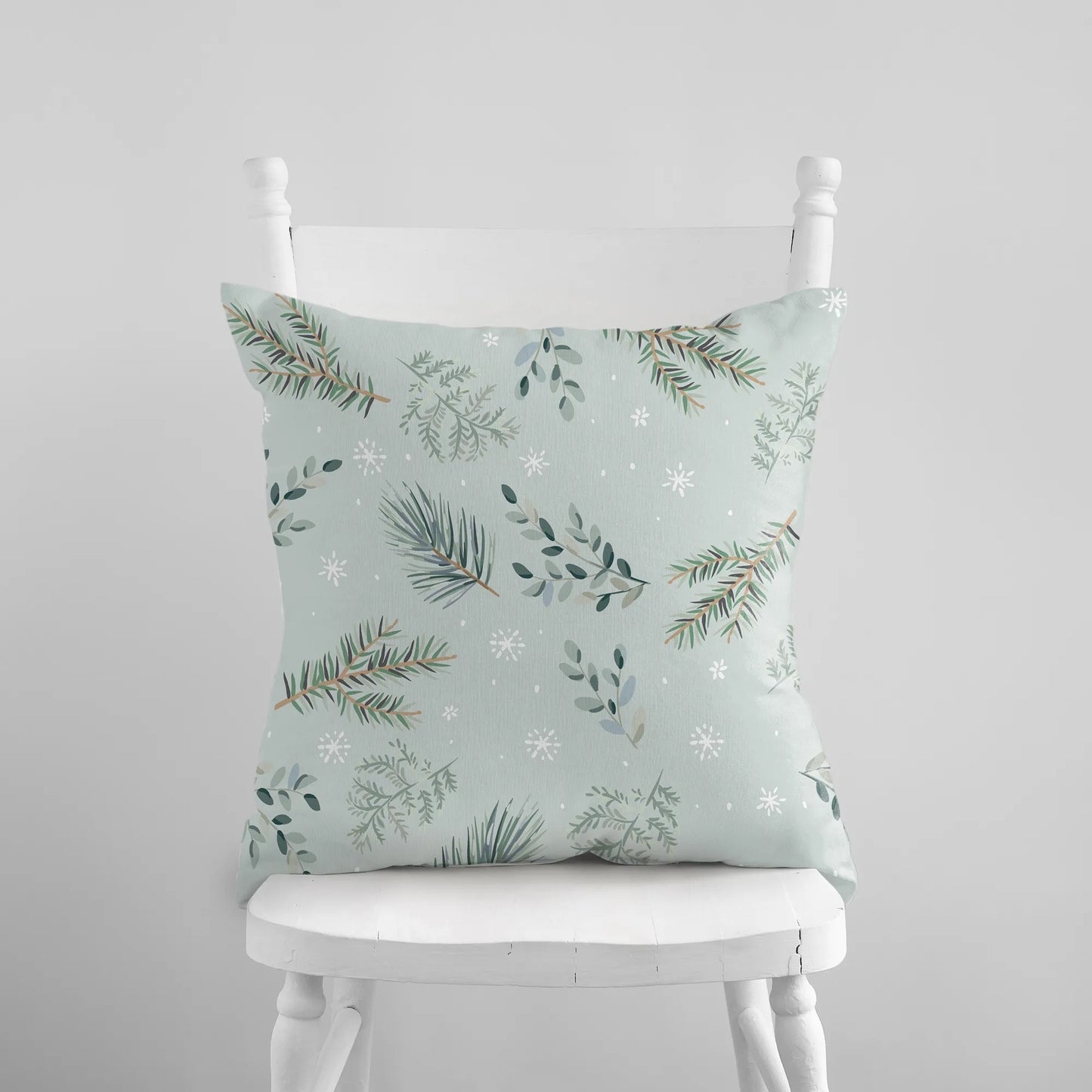white chair with green pine winter pillow from Blue Water Songs