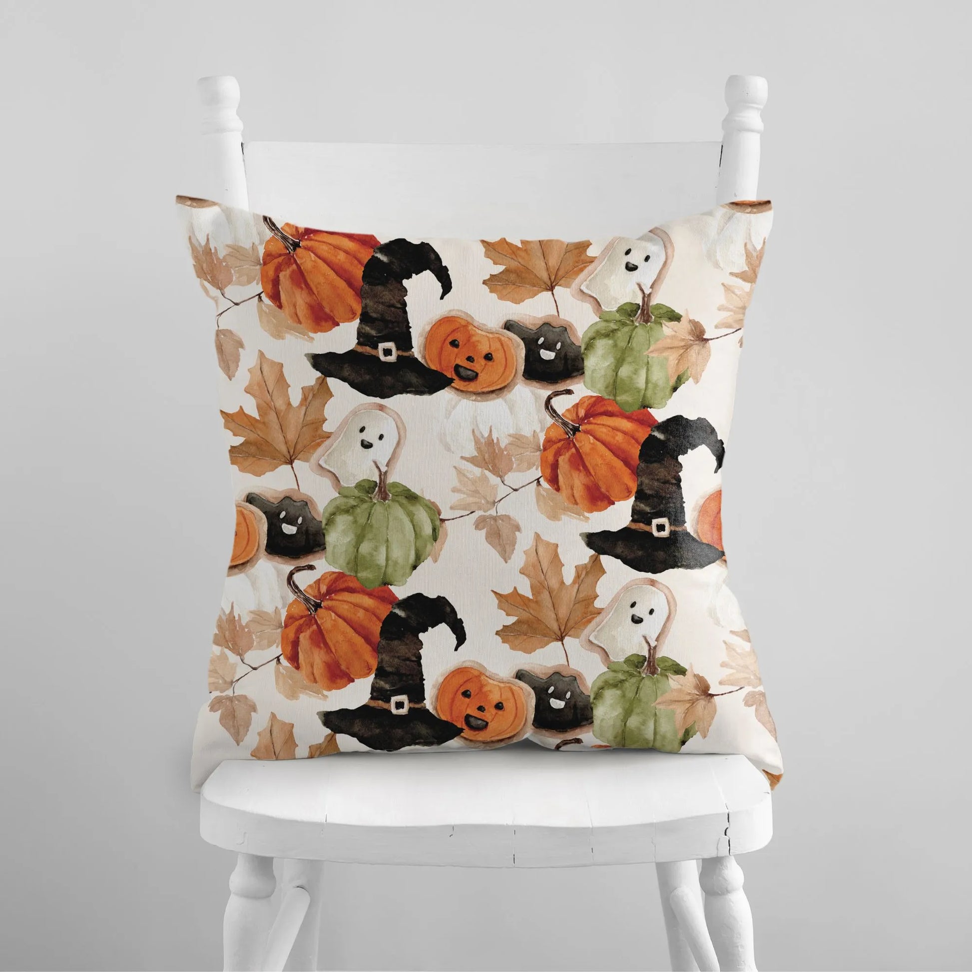 white chair with Watercolor Cute Halloween Pillow from Blue Water Songs on it