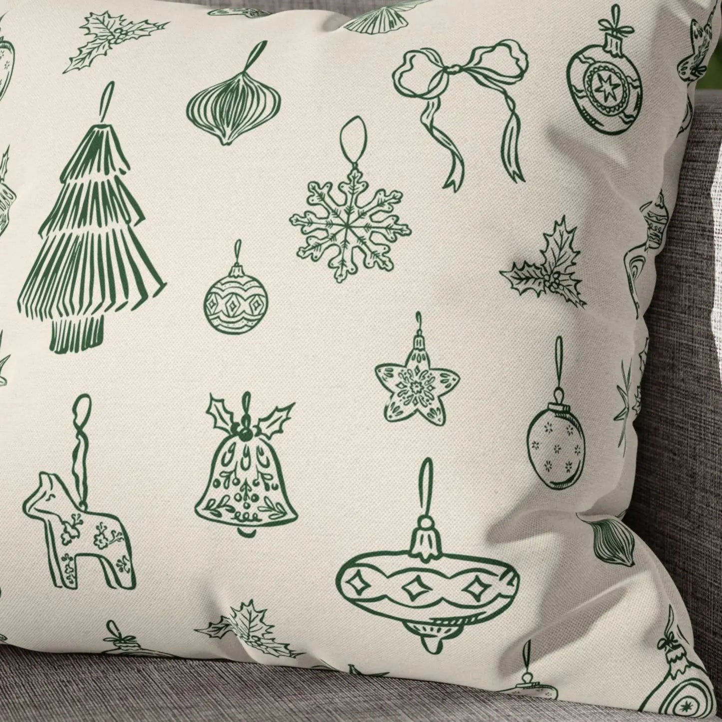 Hand-drawn ornament Christmas pillow with green line-art designs on a neutral background.
