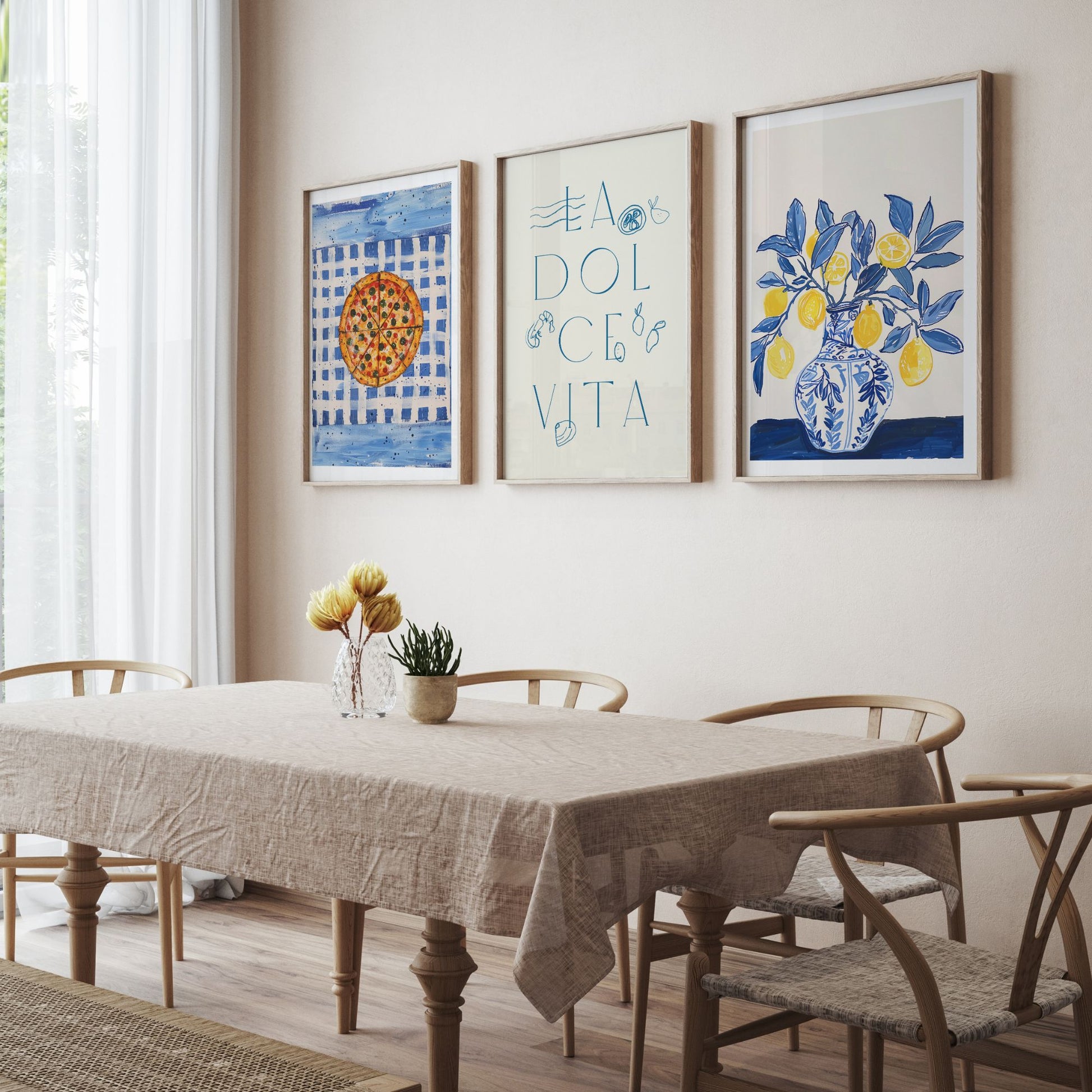 Set of 3 La Dolce Vita printable art prints in wooden frames displayed in a neutral dining room with natural light and a linen-covered table.