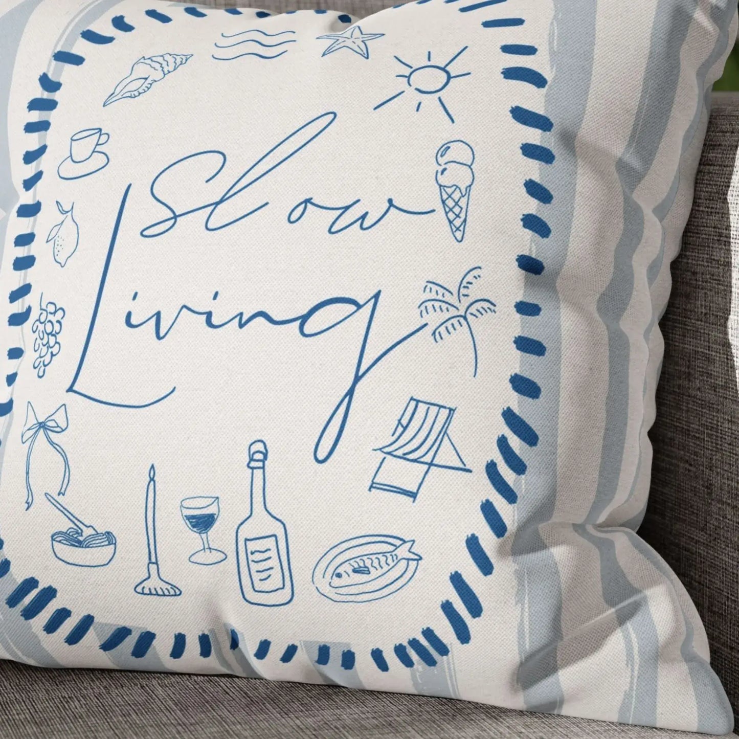 La Dolce Vita Pillow Cover with blue illustrations and the phrase 'Slow Living' on a textured background.