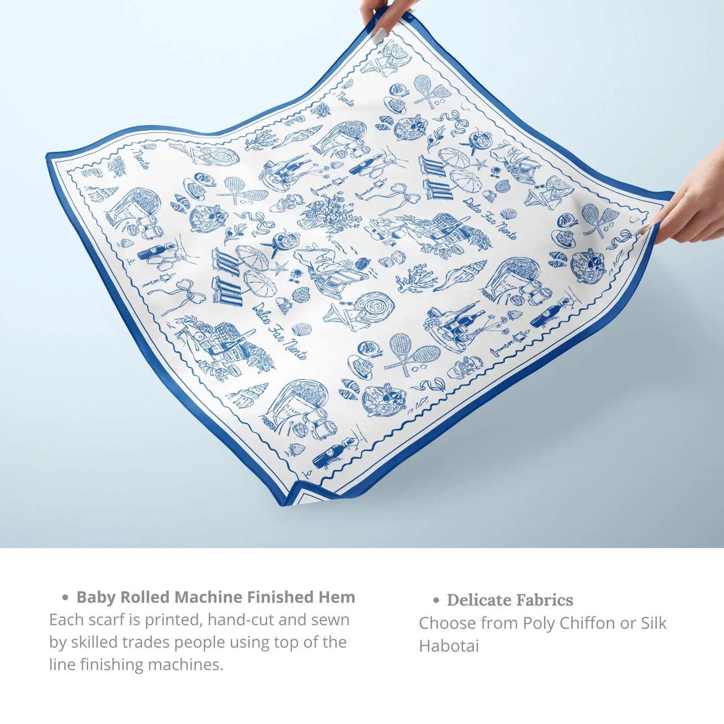 The Dolce Moment Silk Scarf in blue – picnic pattern with baby-rolled hem shown in hand.