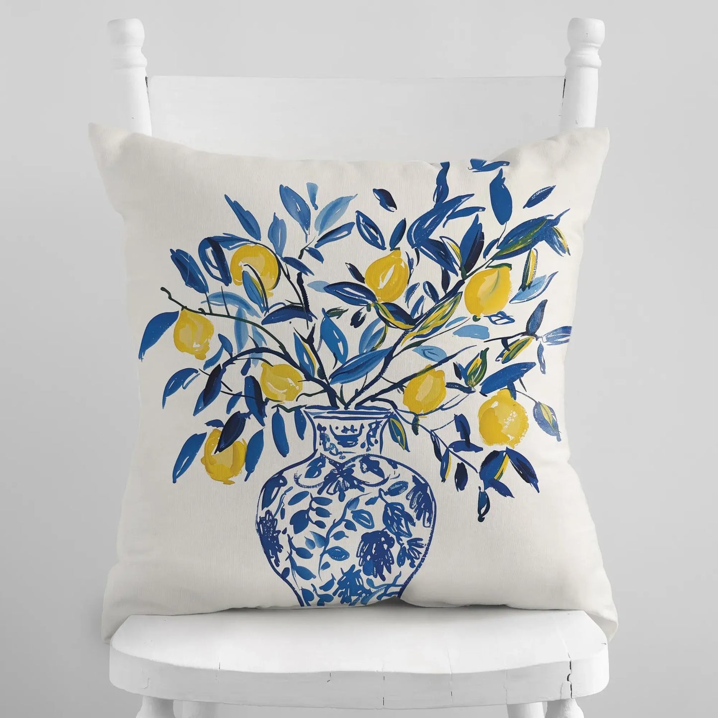 Lemon Pillow featuring yellow lemons in a blue vase, perfect for summer decor and Mediterranean warmth.