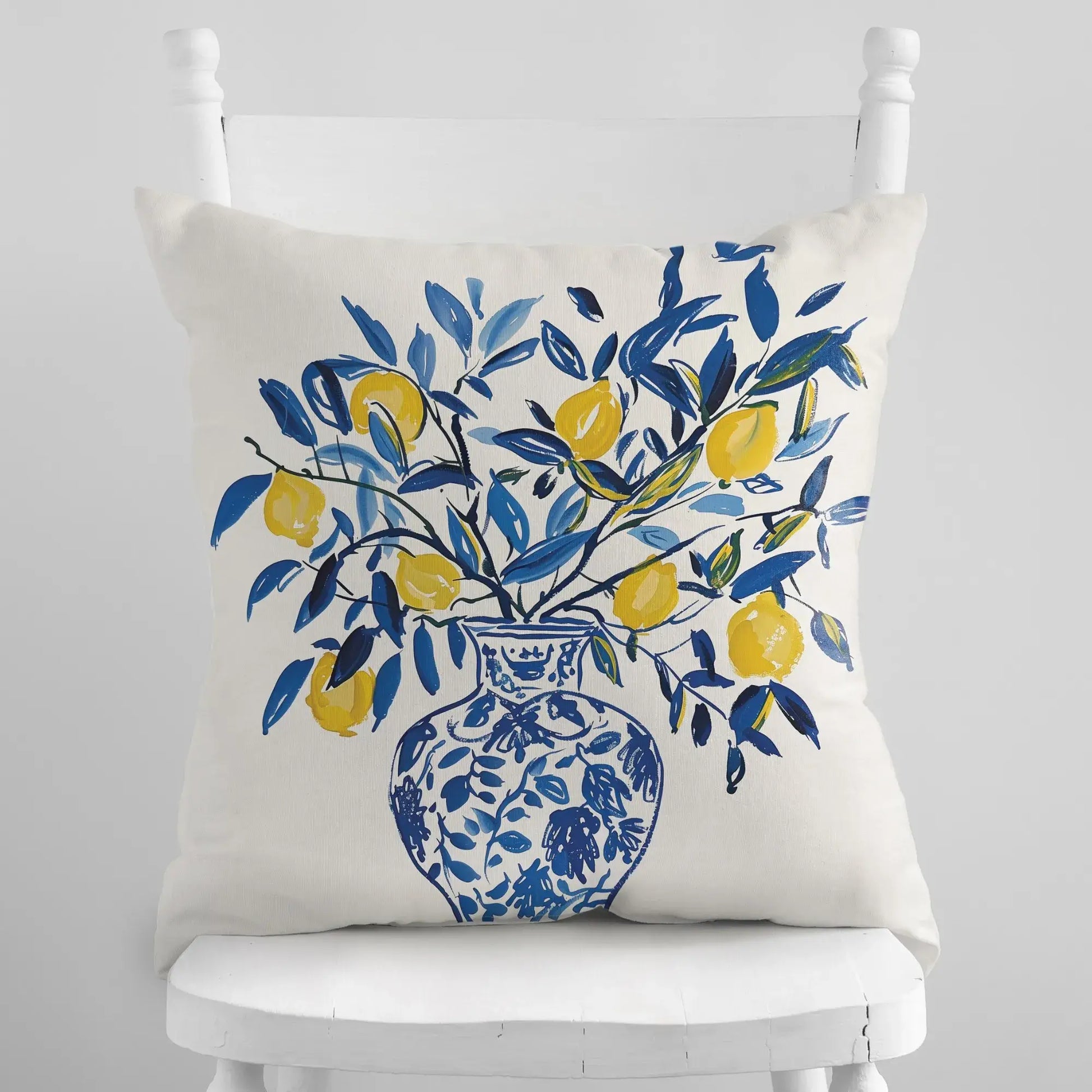 Lemon Pillow featuring yellow lemons in a blue vase, perfect for summer decor and Mediterranean warmth.