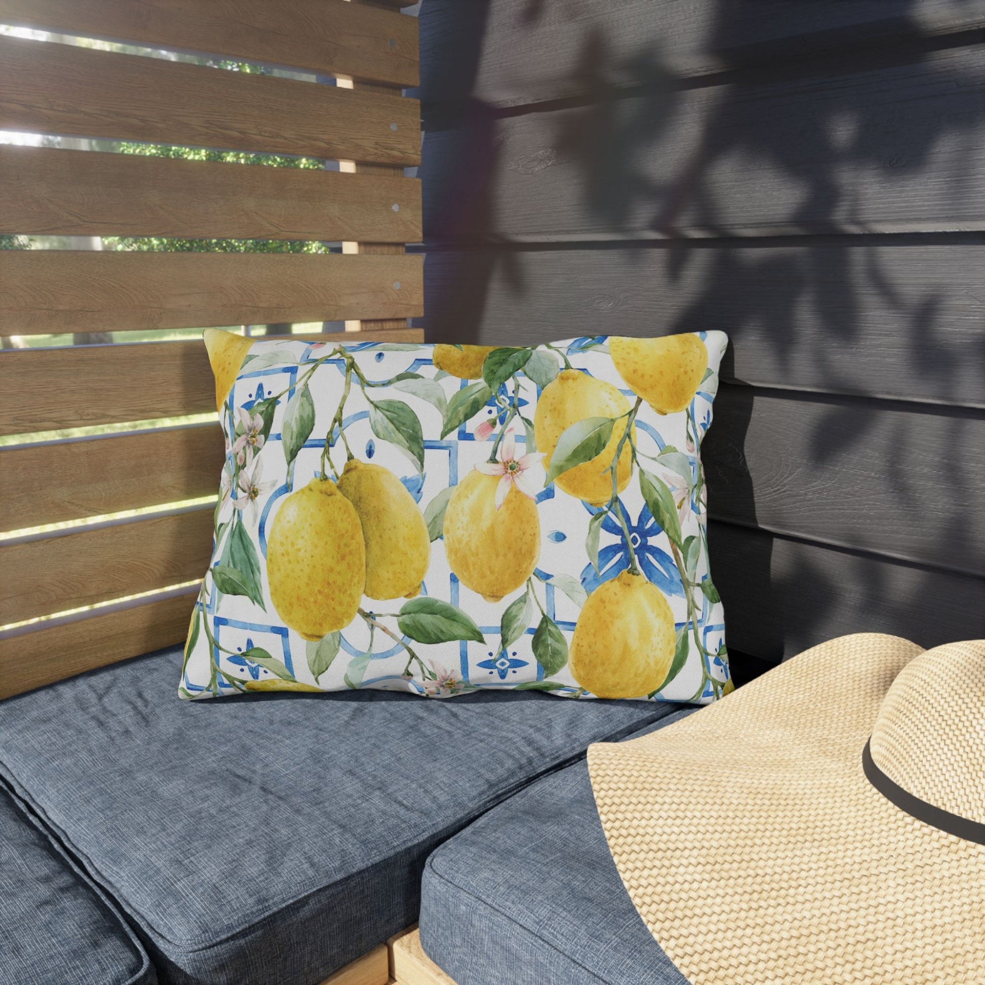 Watercolor Italy Lemon Outdoor Pillow sitting on garden porch