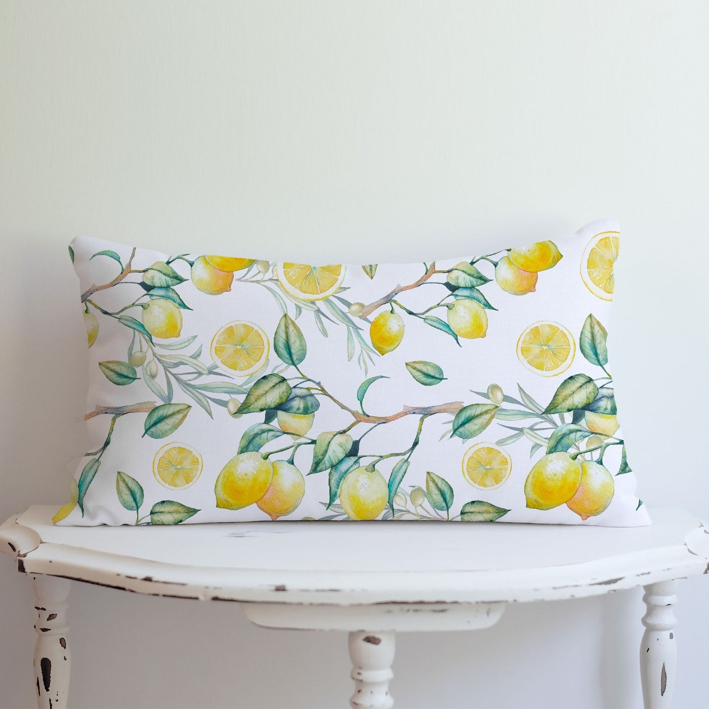 Watercolor lemon pillow cover on vintage white table – vibrant summer home accent.