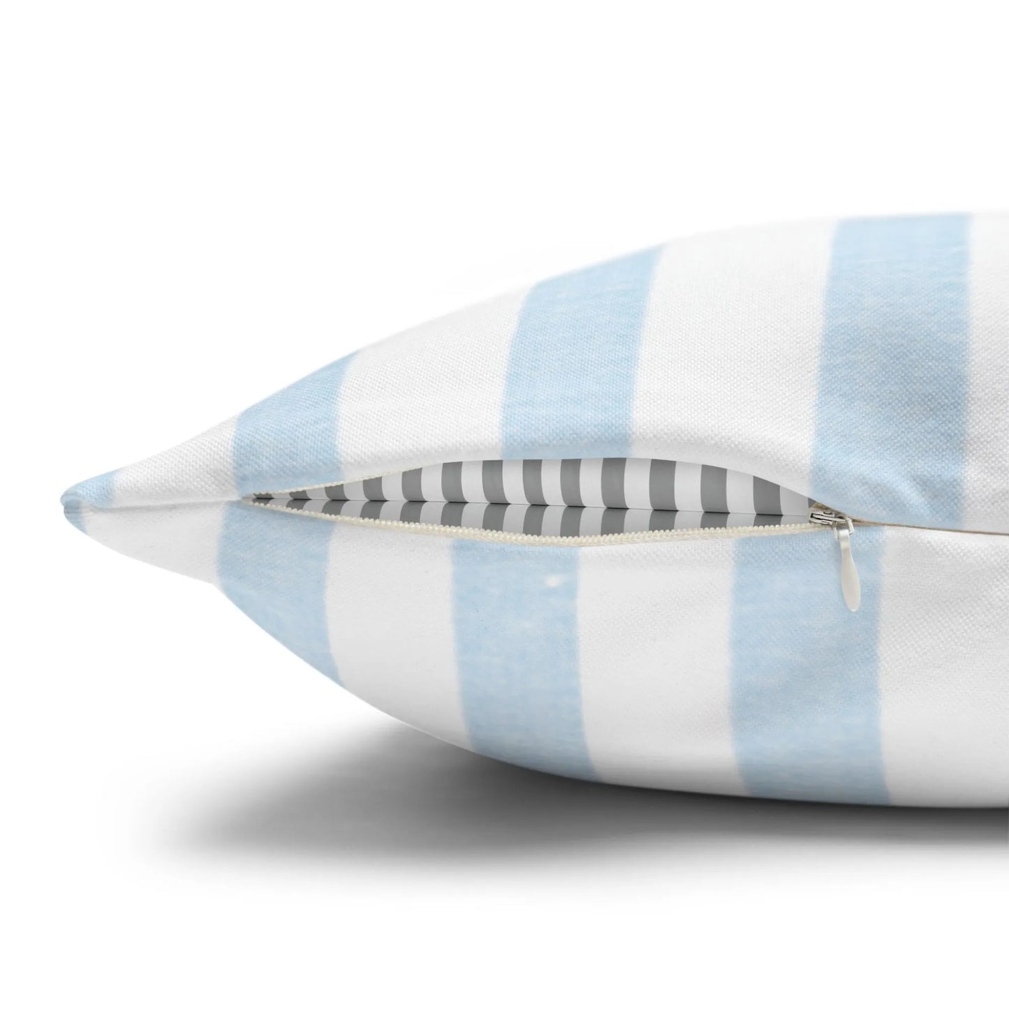 Close-up of hidden zipper on blue and white striped pillow cover.