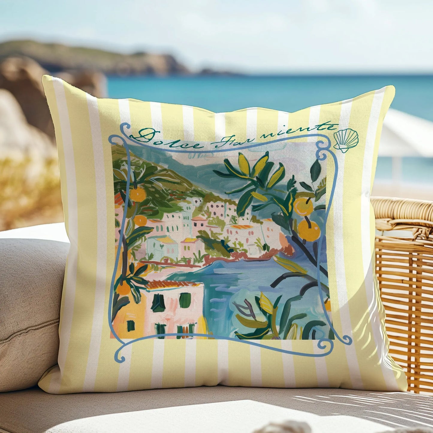 Yellow striped “Dolce Far Niente” lemon pillow styled on outdoor chair by the sea.