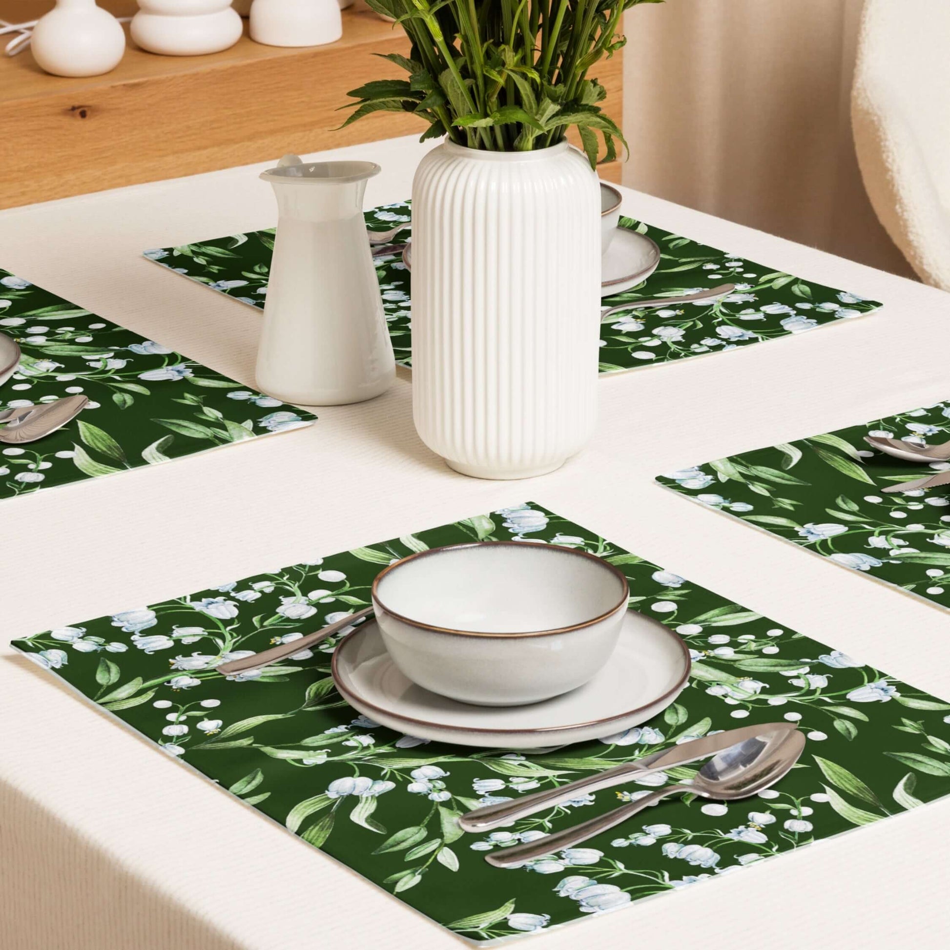 Lily Of The Valley PLACEMAT Set featuring dark green floral design on table with plates and utensils.