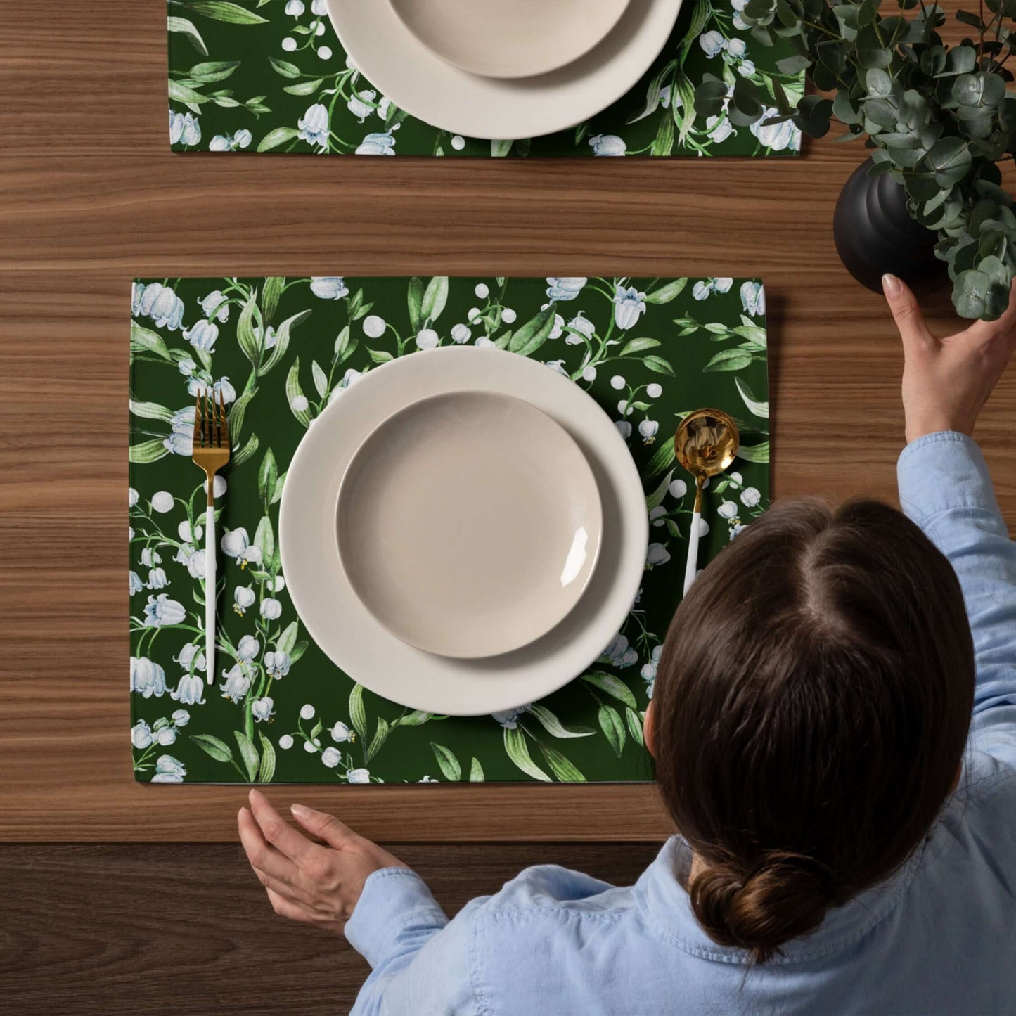 Lily Of The Valley PLACEMAT Set displayed on a wooden table with green floral design and dining plates.