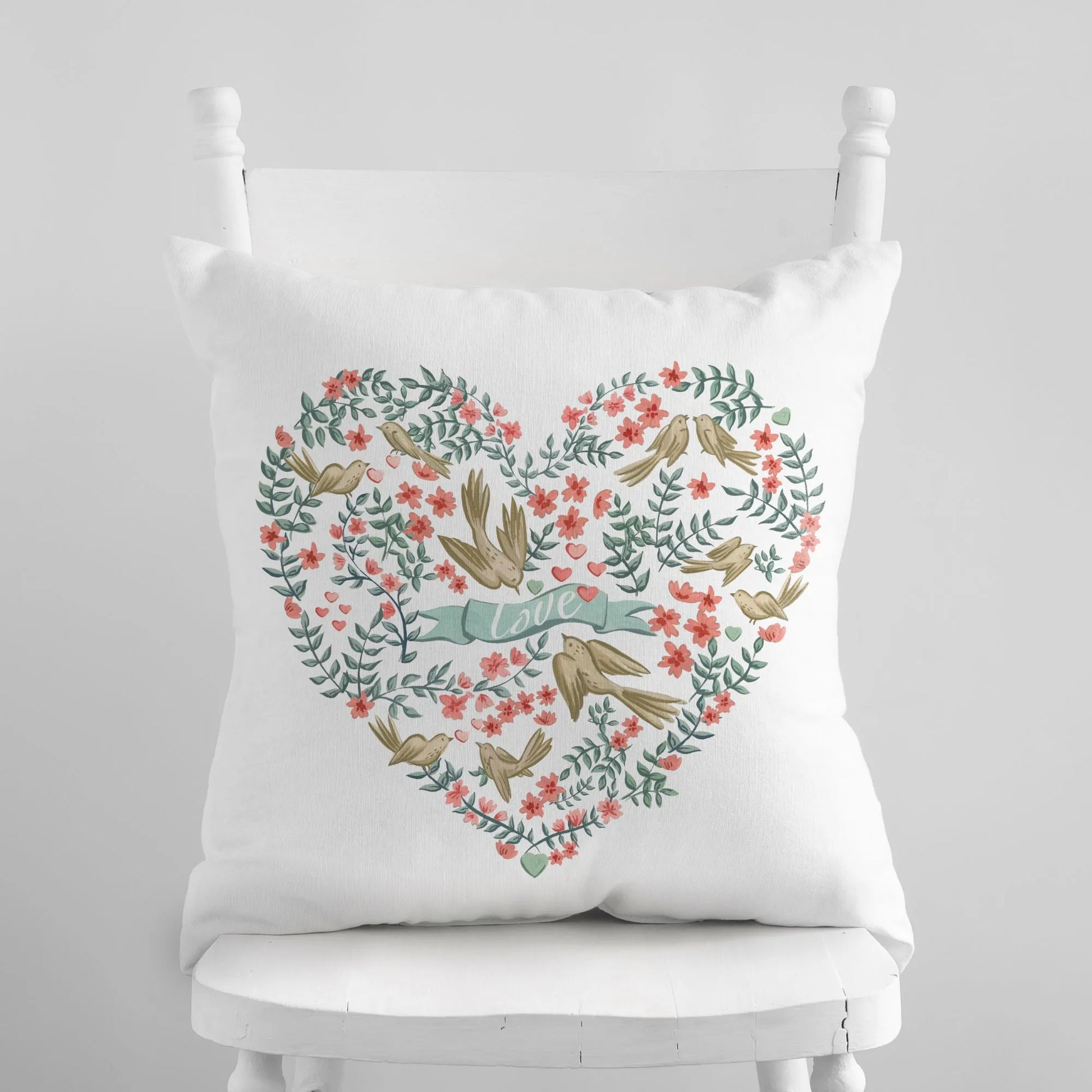white chair and cute love birds throw pillow from Blue Water Songs on it