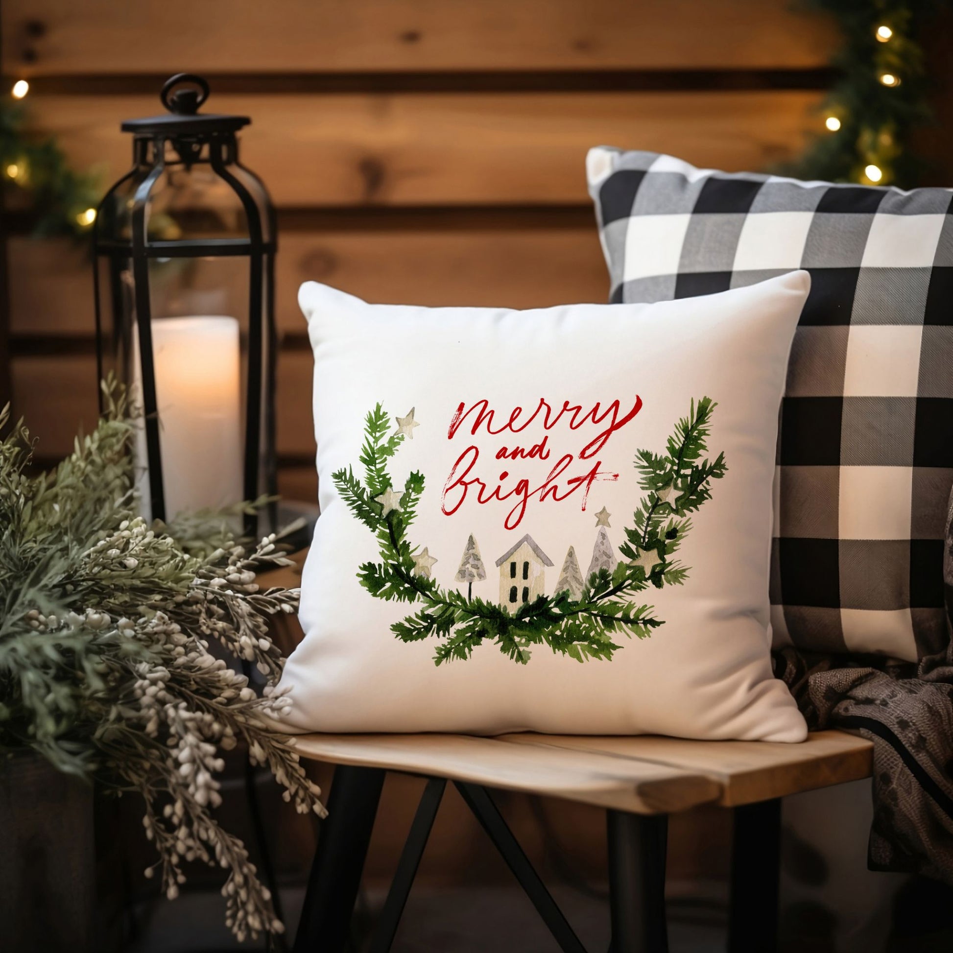 Watercolor Merry and Bright Christmas pillow styled on wooden bench with candle and buffalo plaid cushion – cozy holiday decor