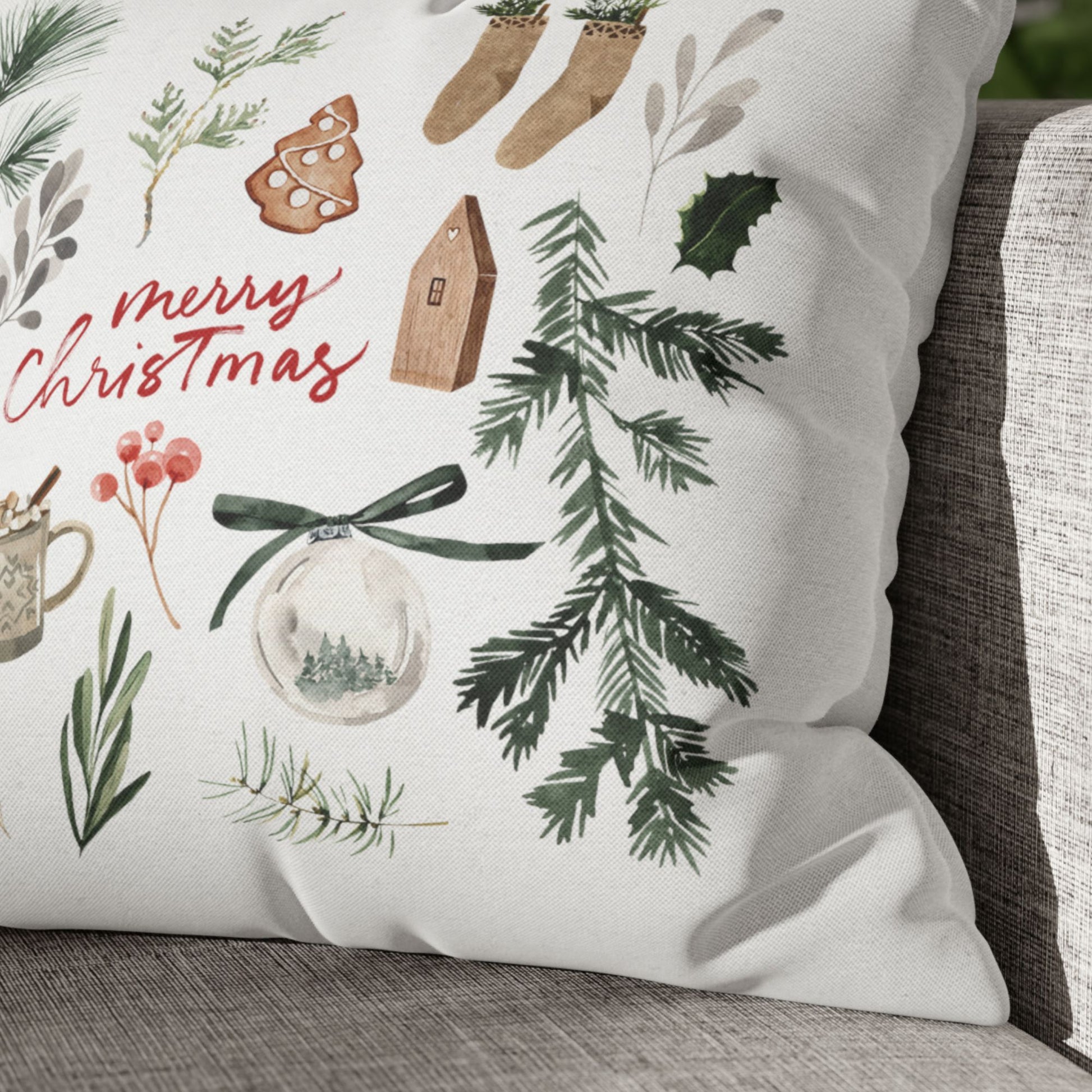 Close-up of Merry Christmas watercolor pillow with festive holiday illustrations and natural greenery details