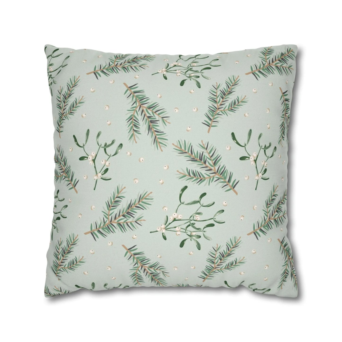 Flat lay of botanical mistletoe Christmas pillow with pine branches and white berries on soft green background