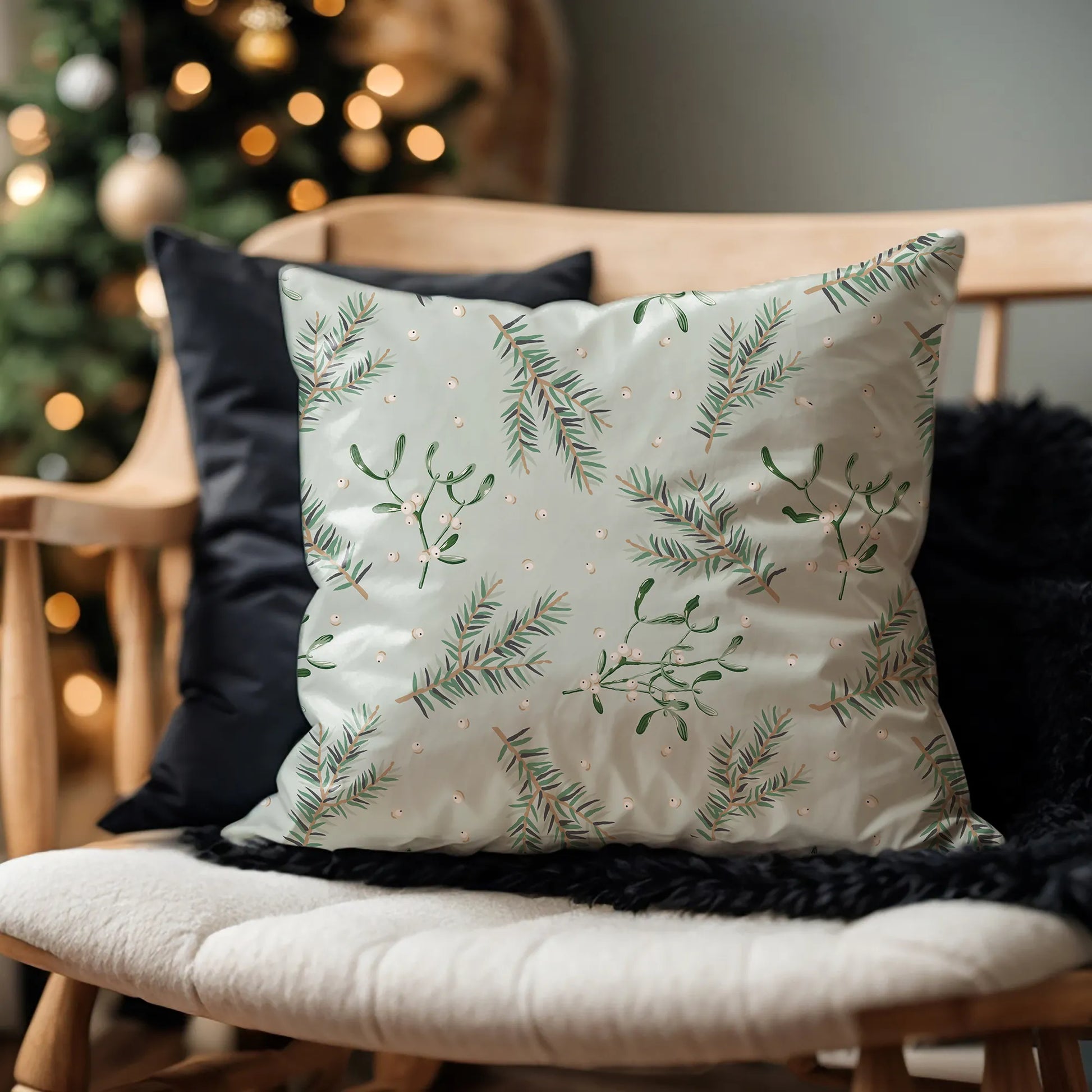 Botanical mistletoe Christmas pillow on wooden bench – cozy holiday decor with pine branches and soft lighting