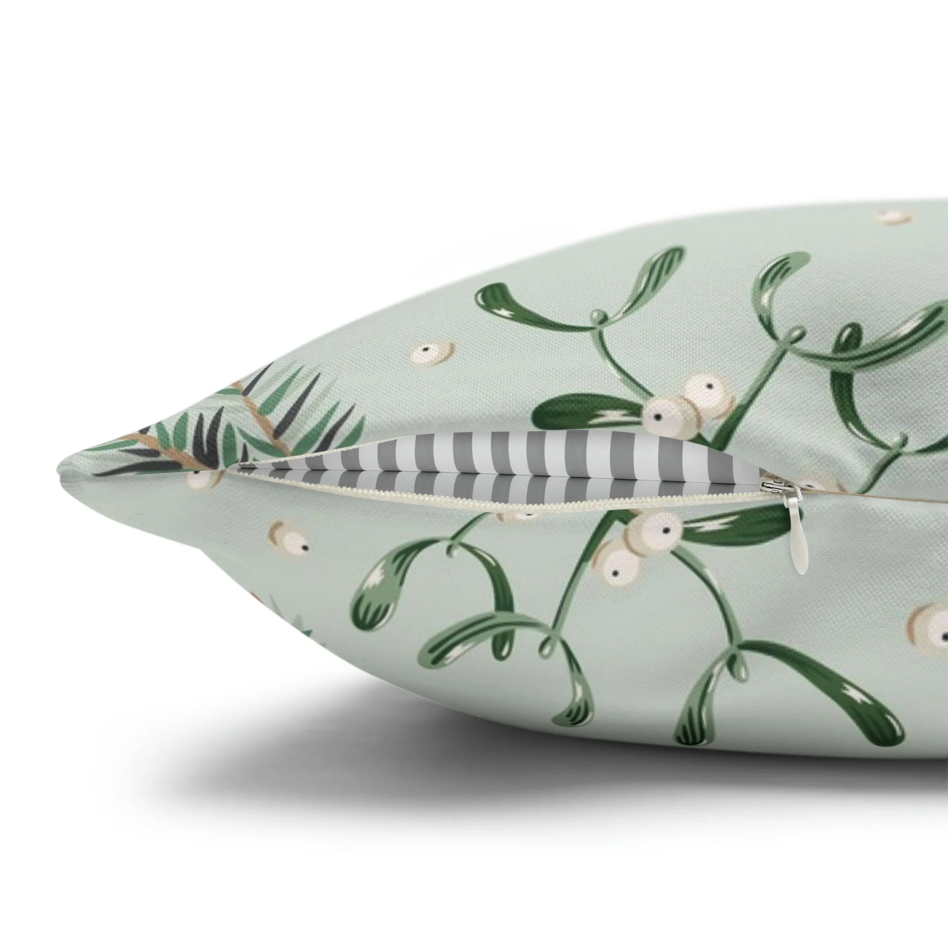 Close-up of mistletoe Christmas pillow with hidden zipper – botanical print with pine and berries on green fabric