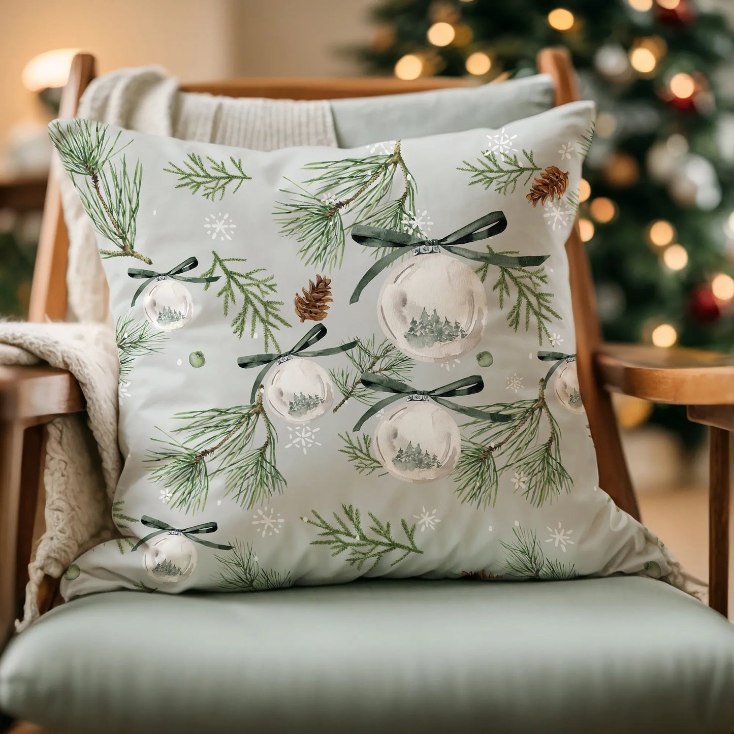 Nature-inspired Christmas pillow with watercolor pine and ornaments on cozy chair – festive winter home decor