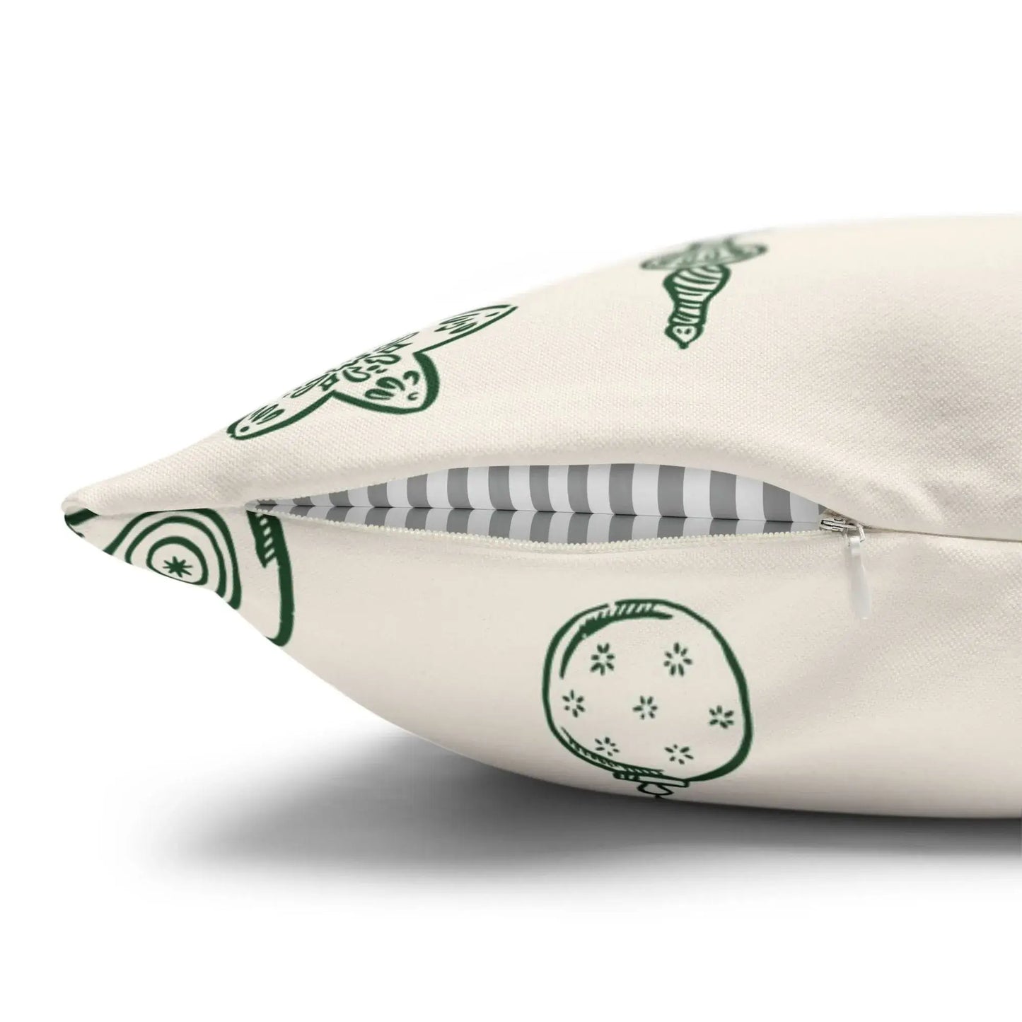Hand-drawn ornament Christmas pillow with a zipper, featuring green line-art designs on a neutral background.