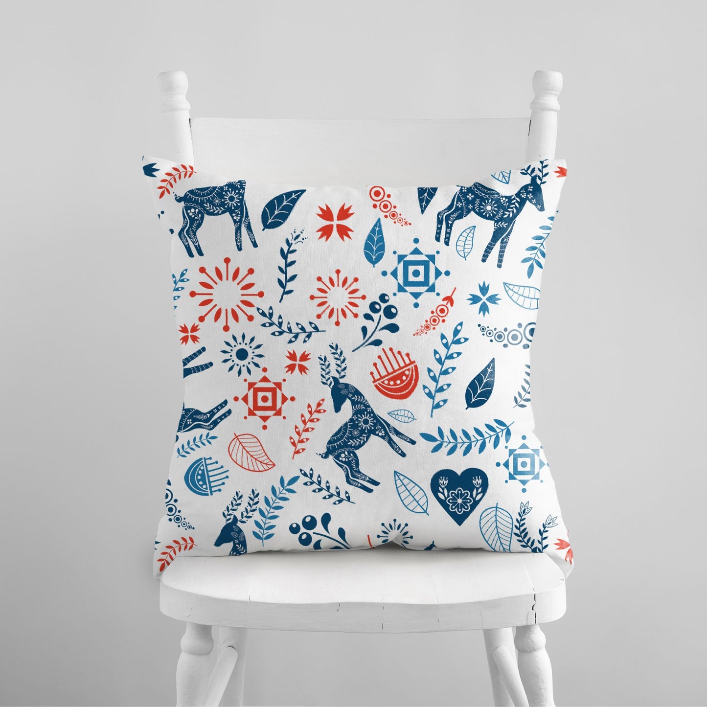 Reindeer Christmas Pillow cover featuring Nordic folk art designs in blue and red floral patterns.