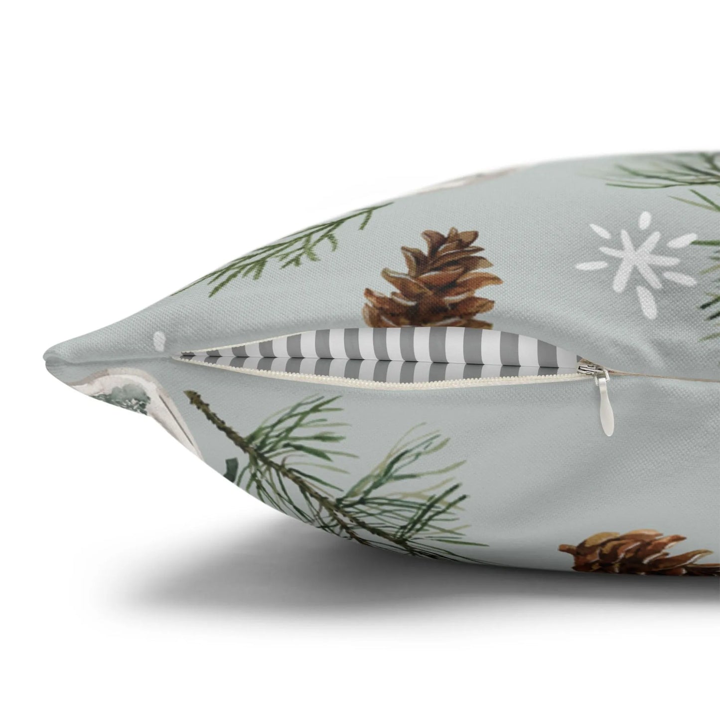 Close-up of pine Christmas pillow with hidden zipper – watercolor pinecone print on soft gray background