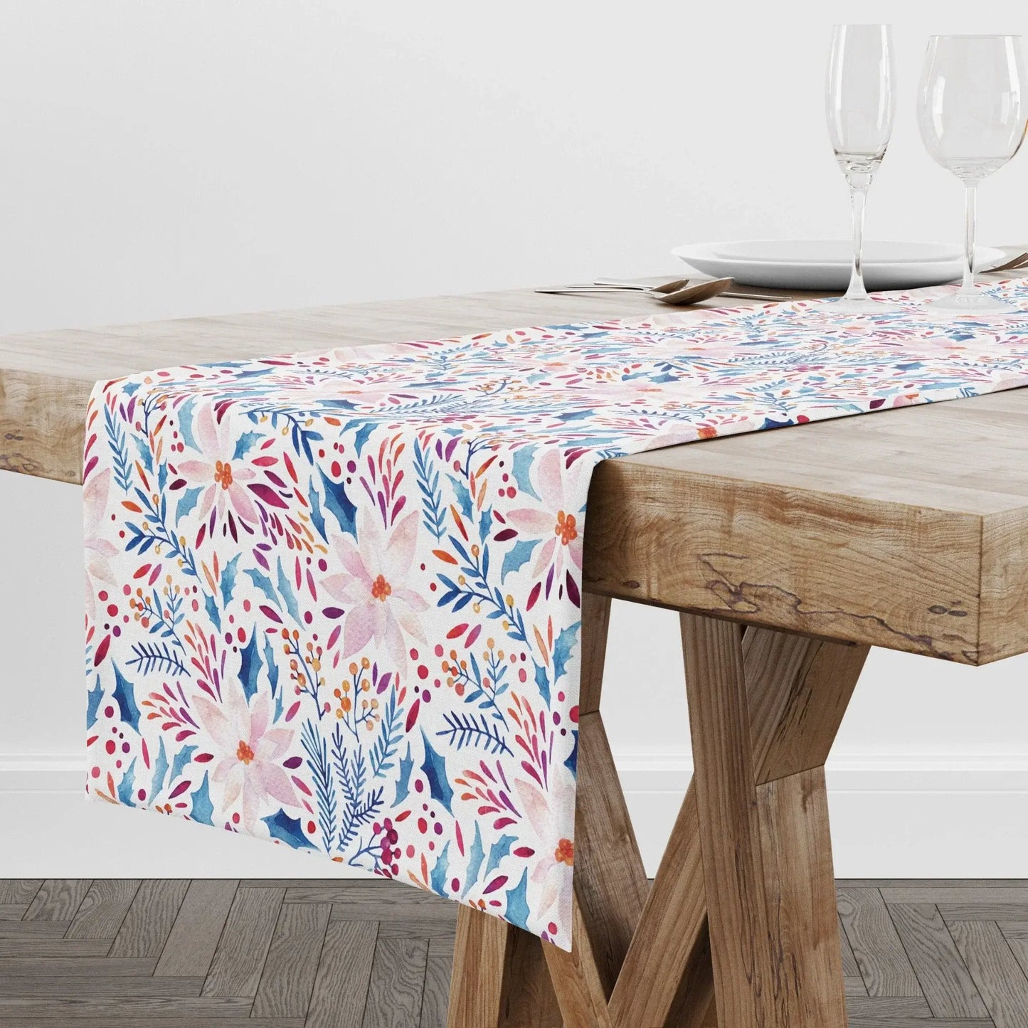 Pink Poinsettia Winter Table Runner displayed on a wooden table with dishes and glasses in a modern dining setting.