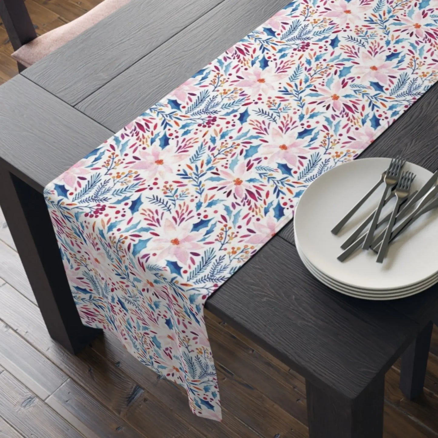 Pink Poinsettia Winter Table Runner featuring vibrant floral patterns on a rustic wooden dining table.