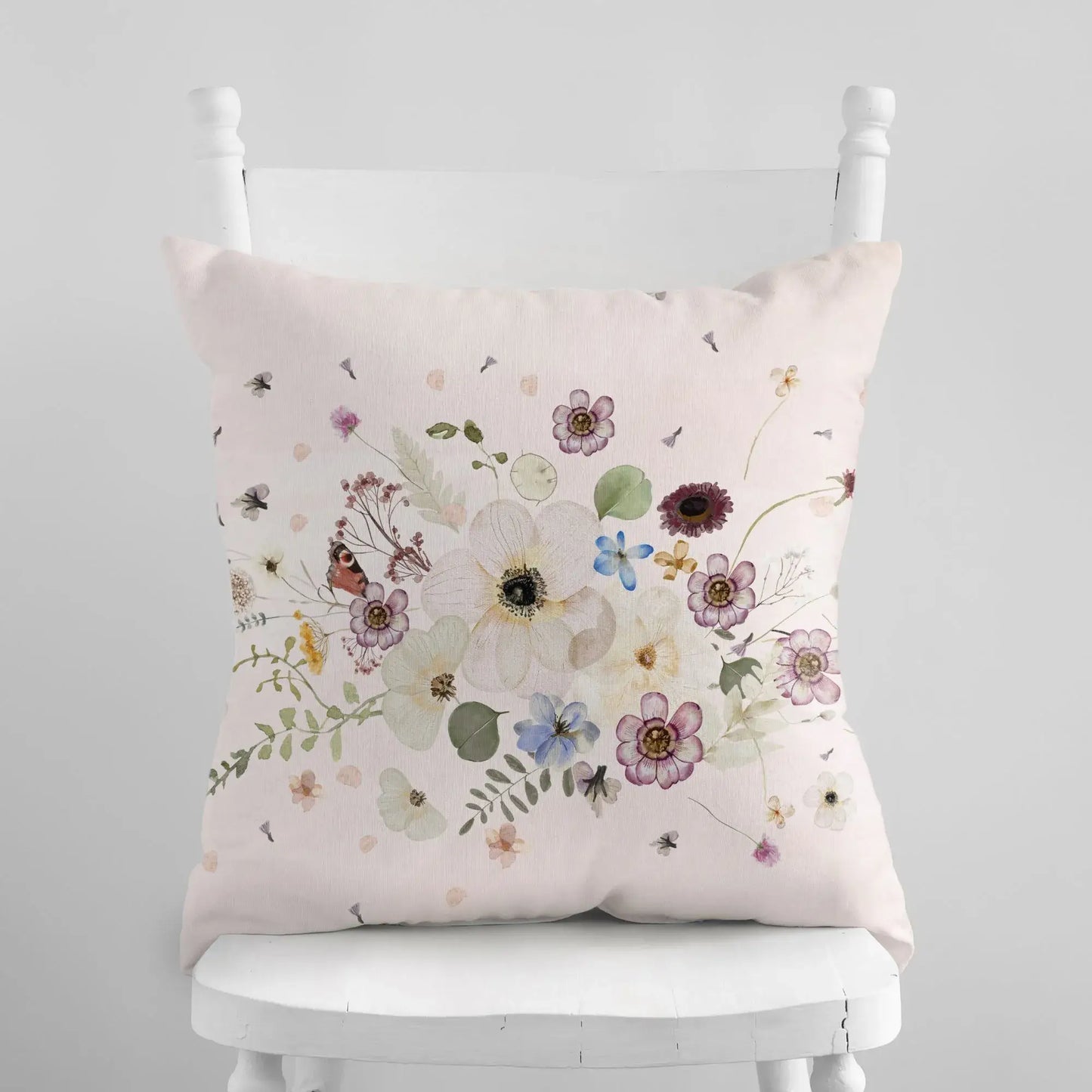 Pressed Flowers spring PILLOW with delicate watercolor florals on a soft pink background.