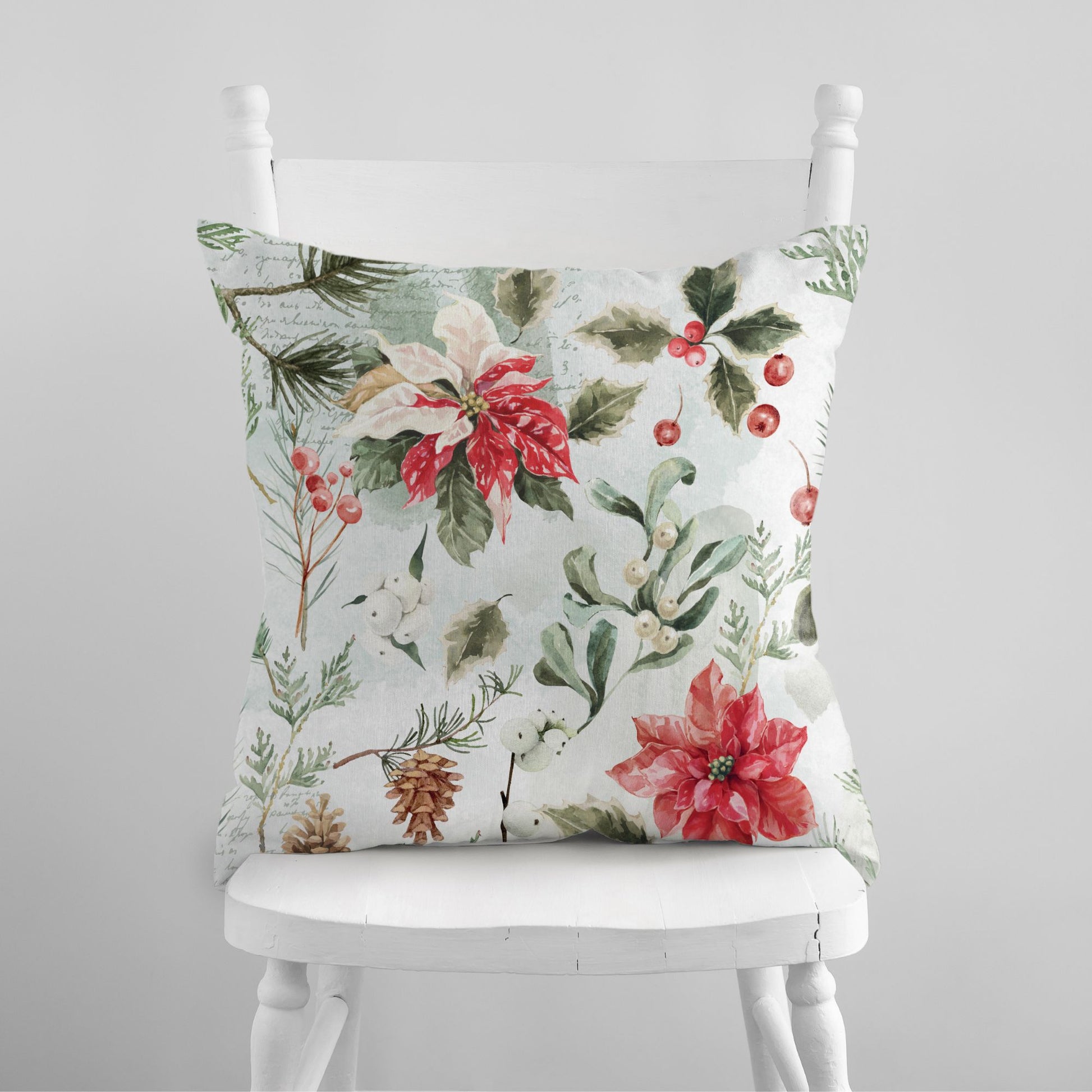 Christmas pillow with watercolor poinsettias, holly, berries, and pine branches