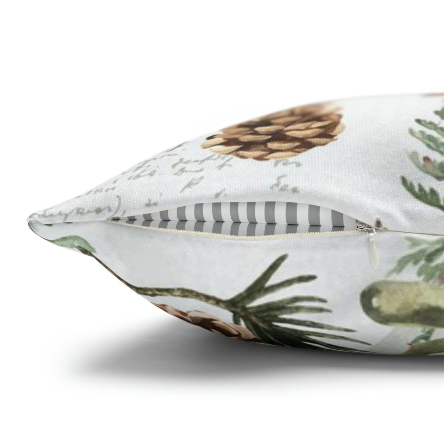 Close-up of Christmas pillow zipper with pinecone and botanical print