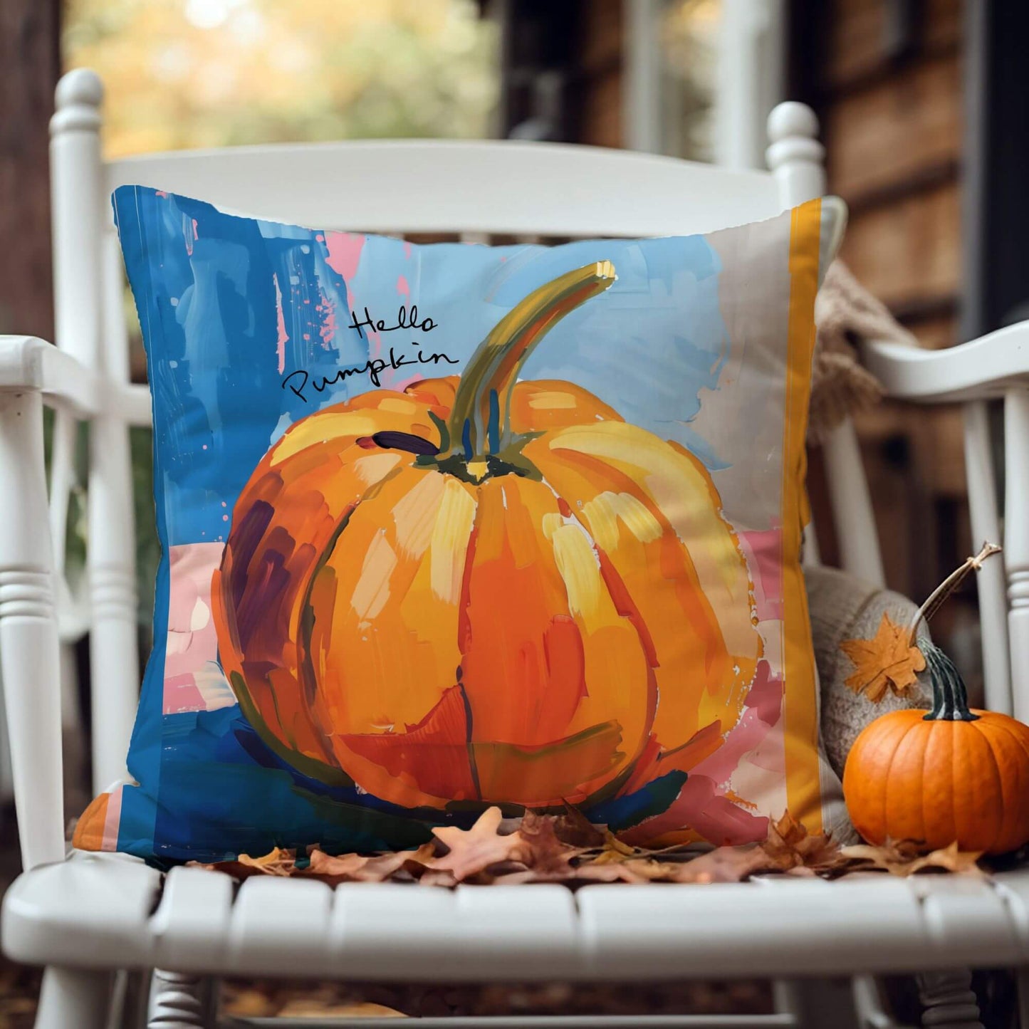 Pumpkin pillow cover fall decor featuring a vibrant watercolor pumpkin illustration on a cozy chair.