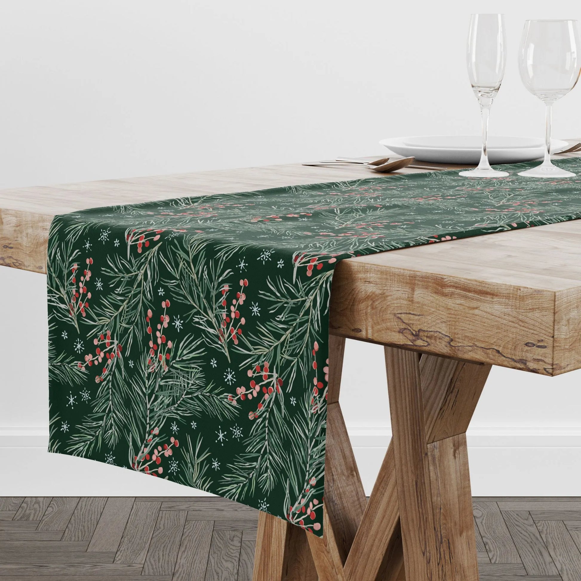 Scandinavian wood table with green winter table runner on it