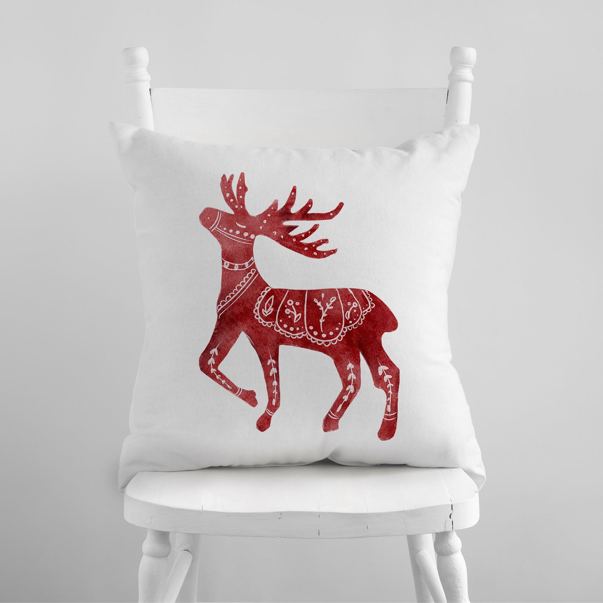 Red Deer Nordic Christmas PILLOW sitting on white chair