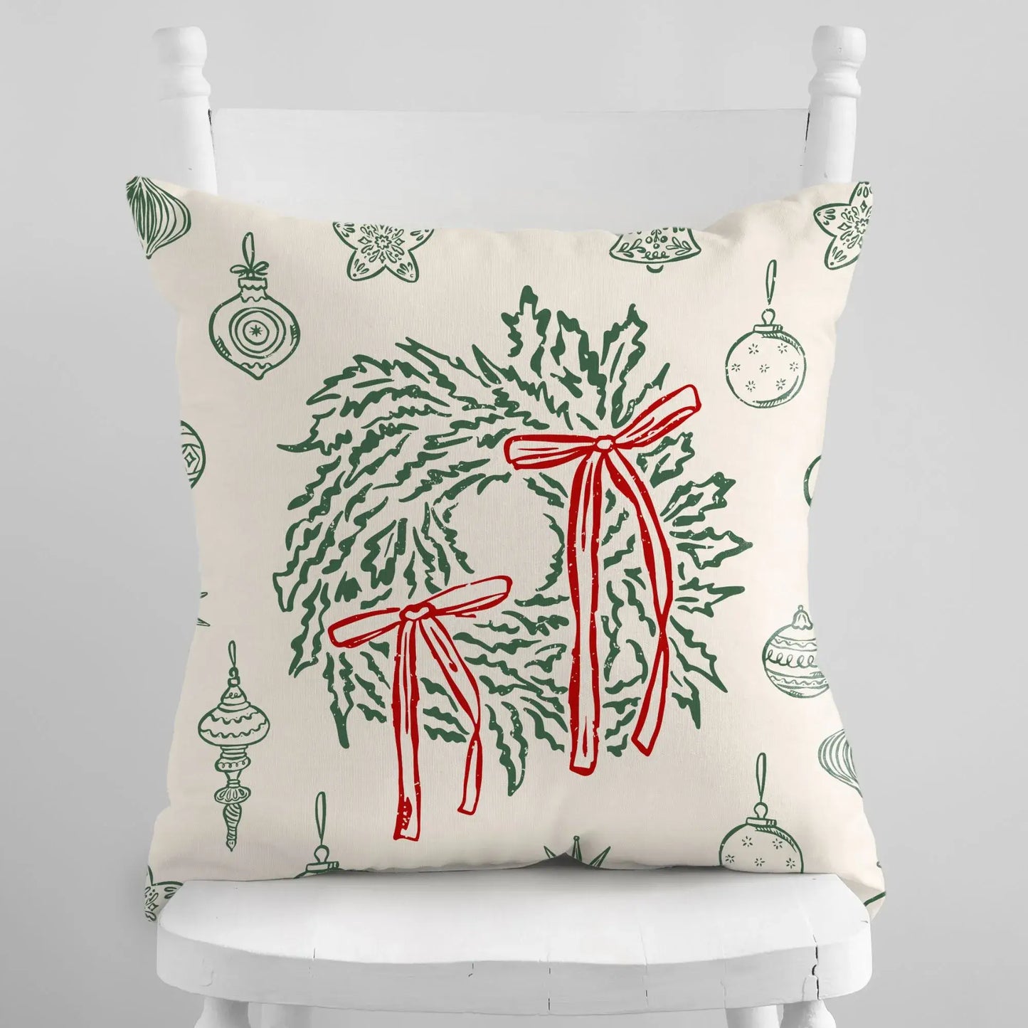 Retro Christmas Pillow featuring green wreaths and red bows on a festive ivory background.