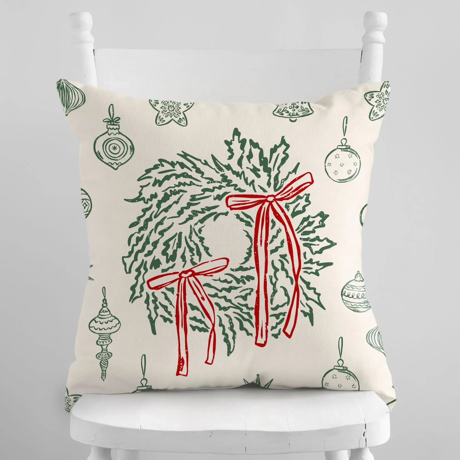 Retro Christmas Pillow featuring green wreaths and red bows on a festive ivory background.