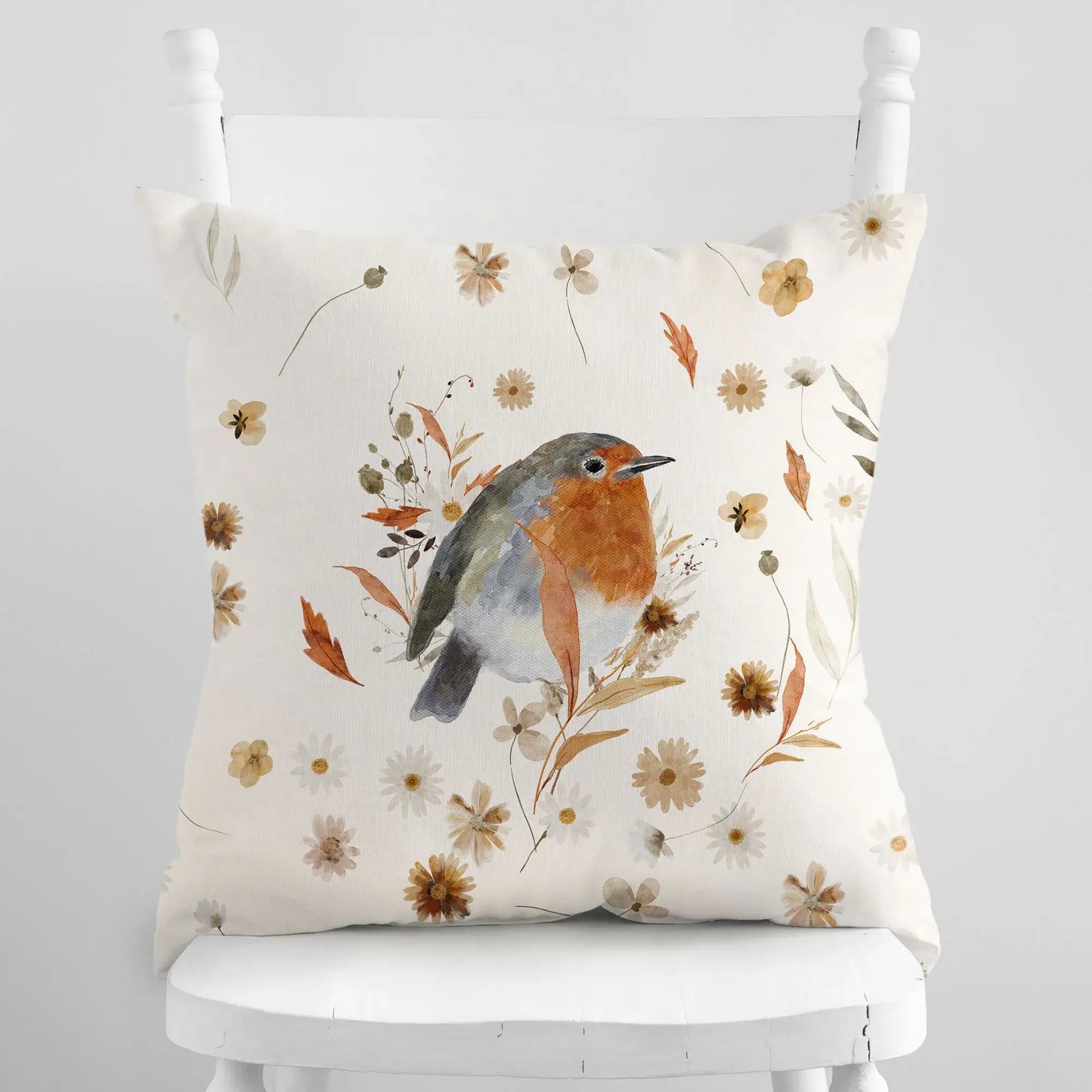 Robin bird fall pillow covers with fall wildflowers on white chair – autumn botanical cushion for seasonal home decor