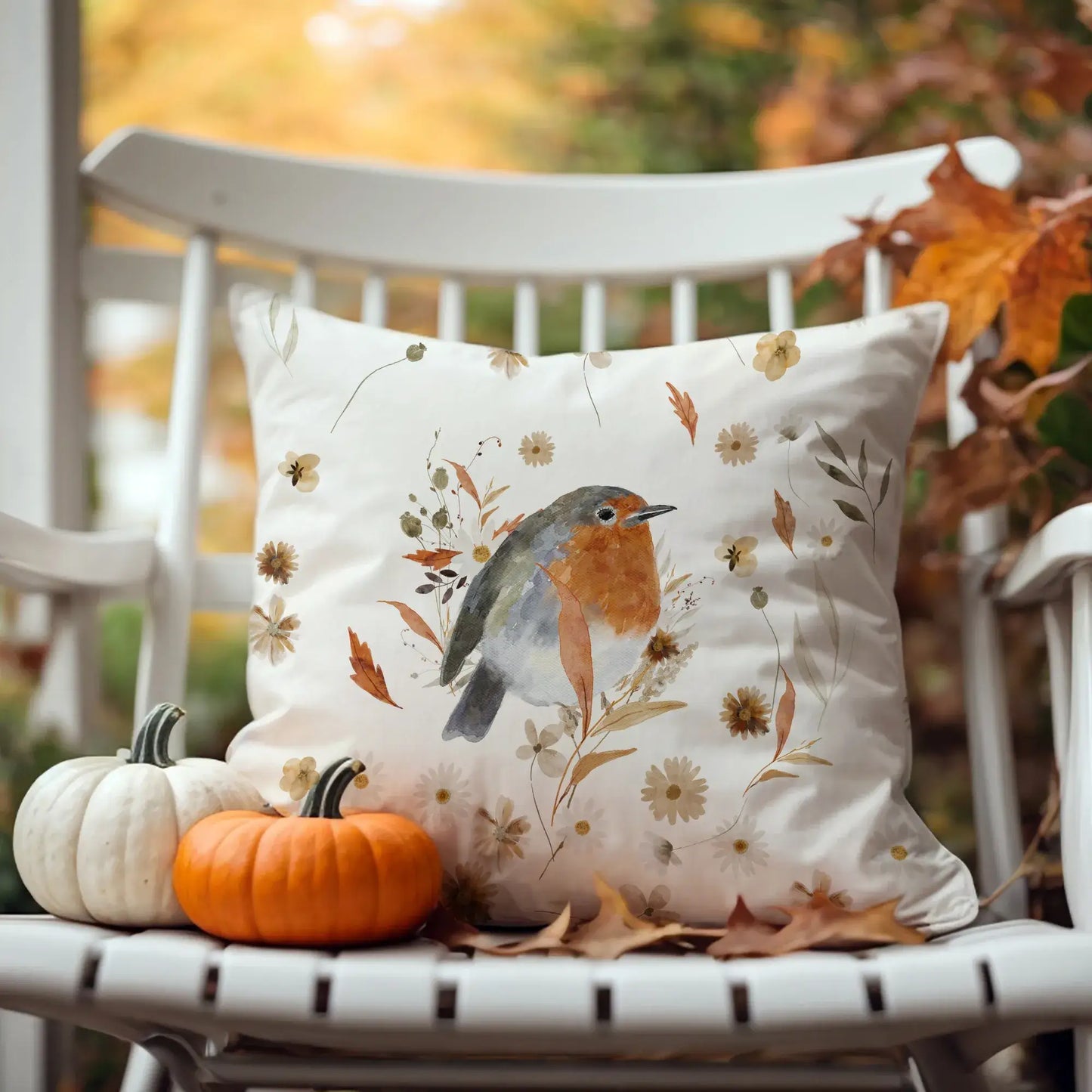 Robin bird fall pillow covers with fall wildflowers on white chair, pumpkins and autumn leaves – cozy seasonal decor