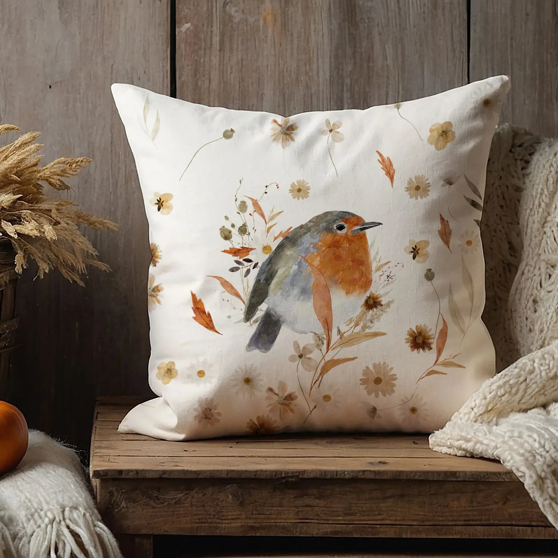 Robin bird fall pillow covers with fall wildflowers styled on rustic wooden bench – cozy autumn home decor cushion