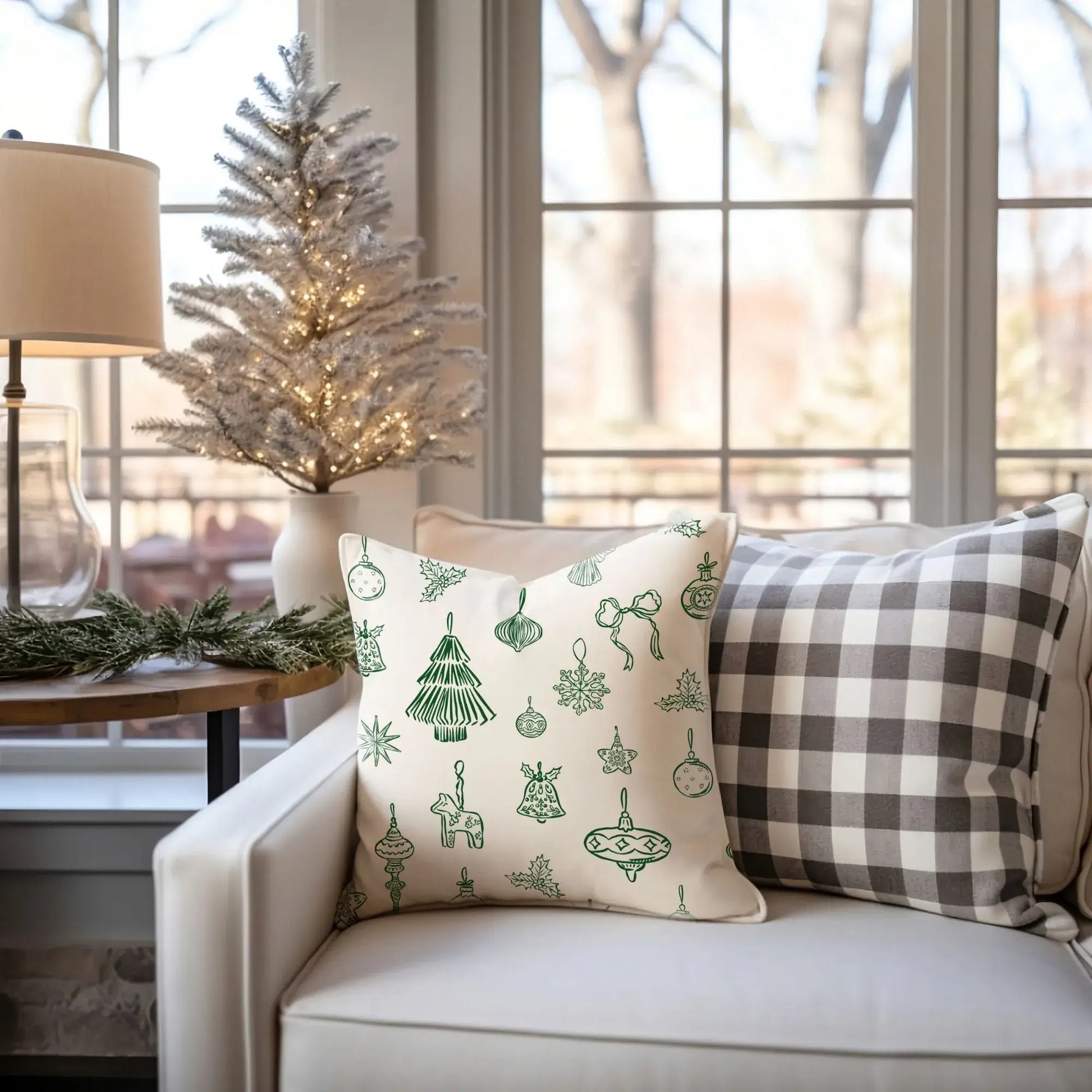 Hand-Drawn Red Ornament Christmas Pillow on a couch, featuring decorative green ornaments, perfect for a festive home decor.