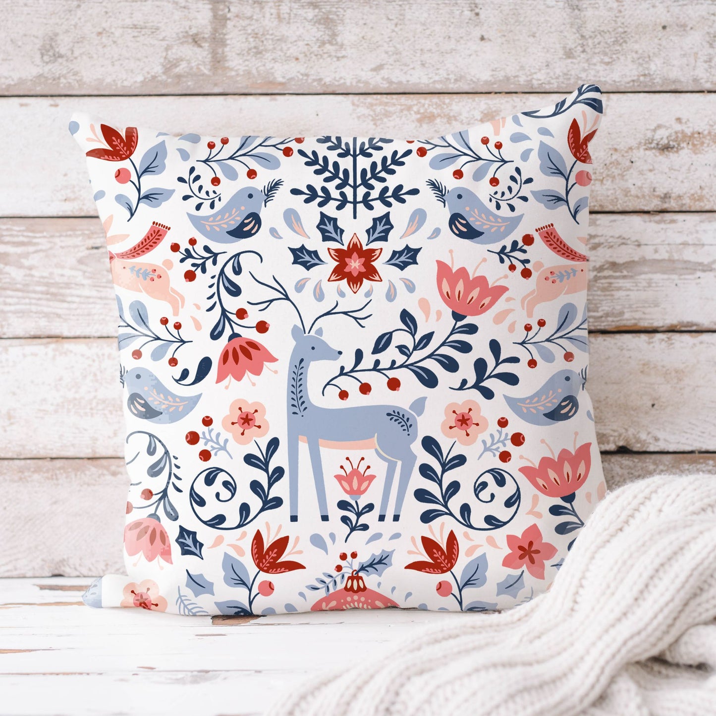 Nordic Reindeer Christmas Pillow featuring floral patterns and birds on a cozy background.