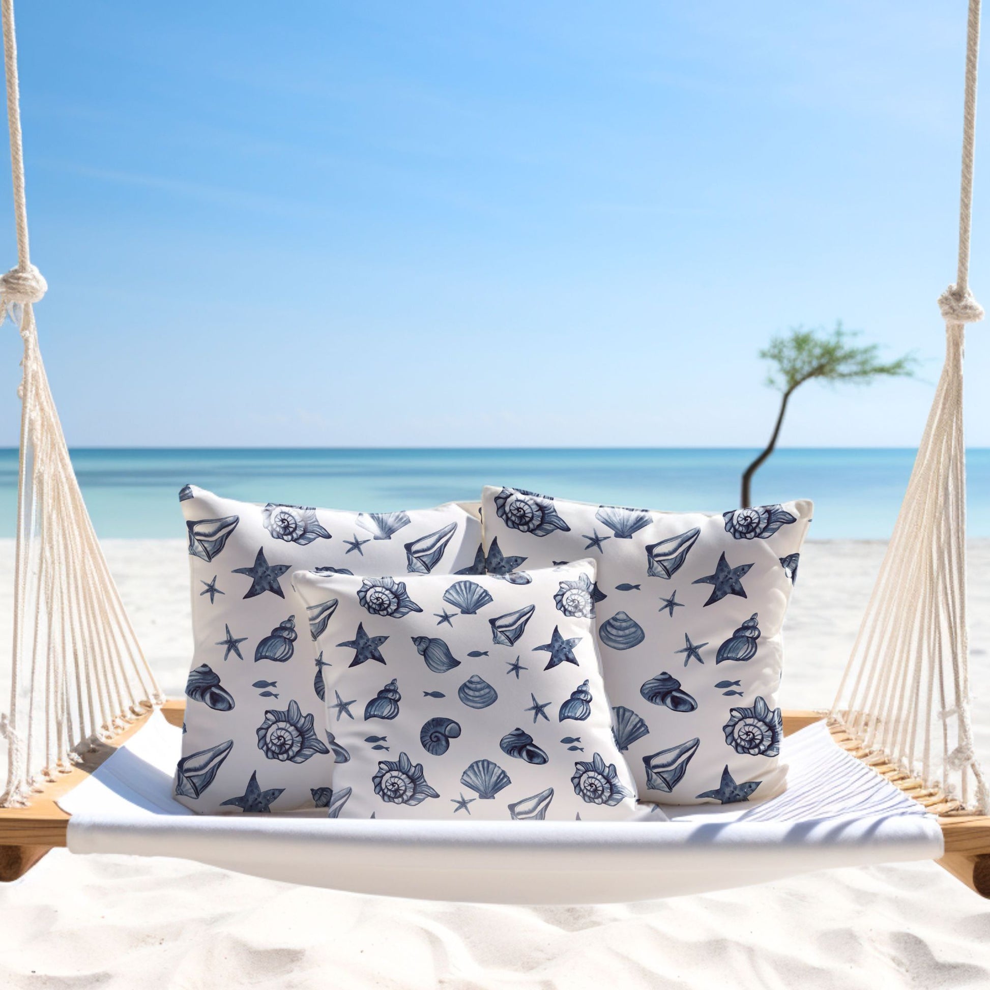 Blue seashell pillows on white swing — coastal home decor